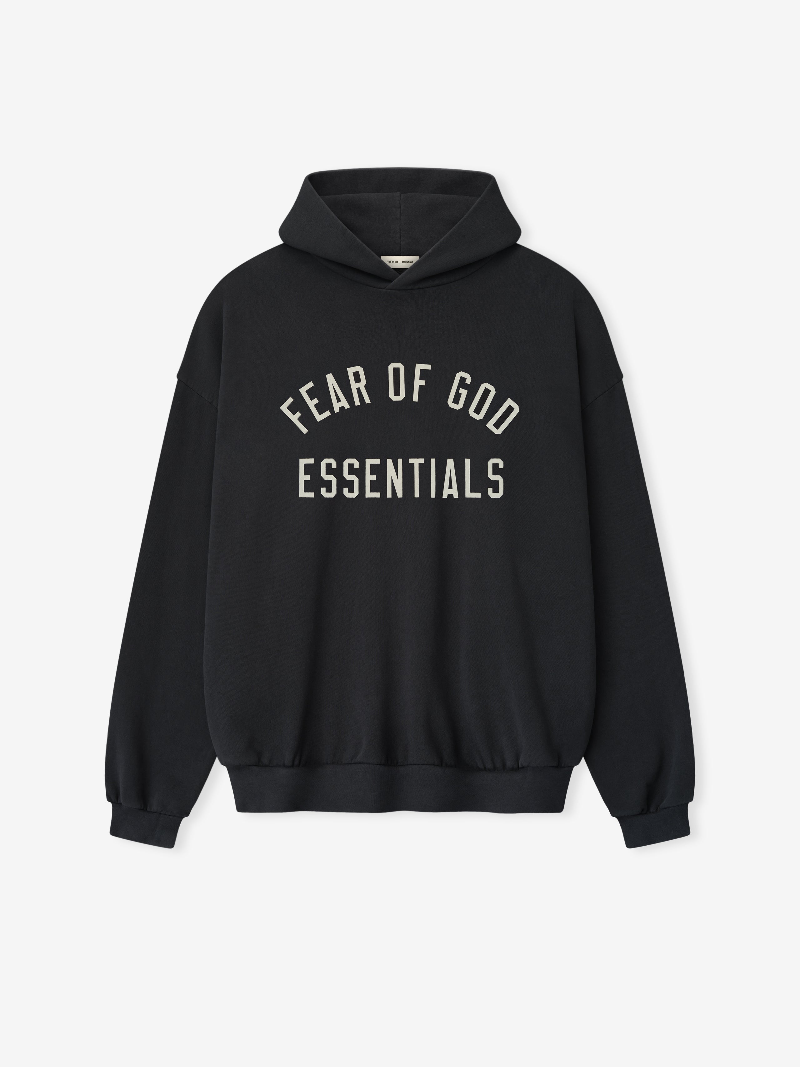 Black oversized hoodie with a hood and fleece lining, featuring "Fear of God Essentials" printed in large white letters