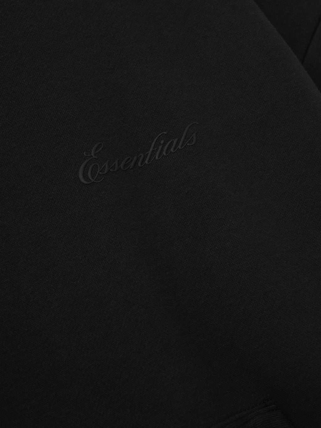 Black hoodie with 'Essentials' script logo