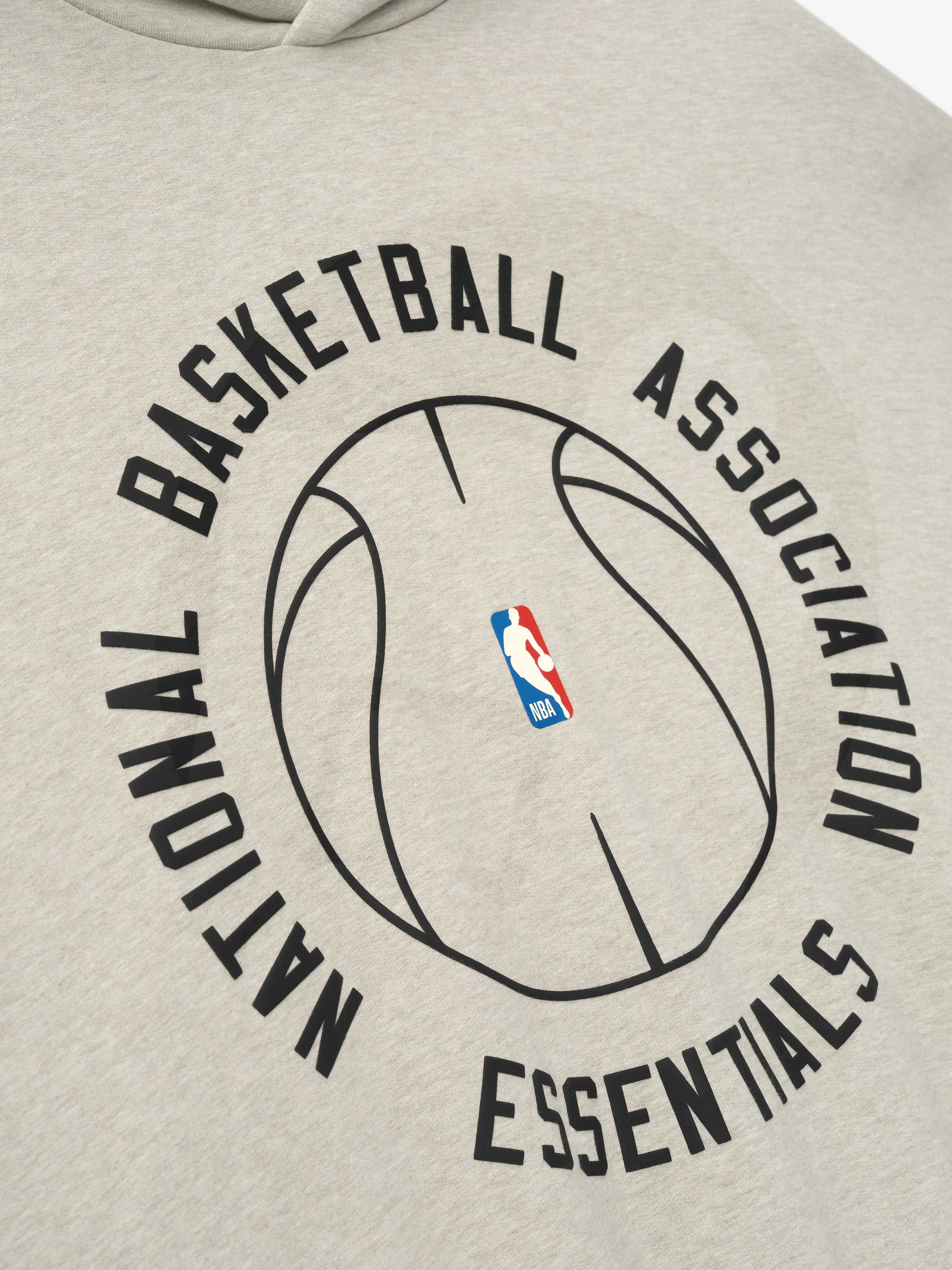 beige heavyweight hoodie with outlined basketball and circular National Basketball Association Essentials text graphic on front