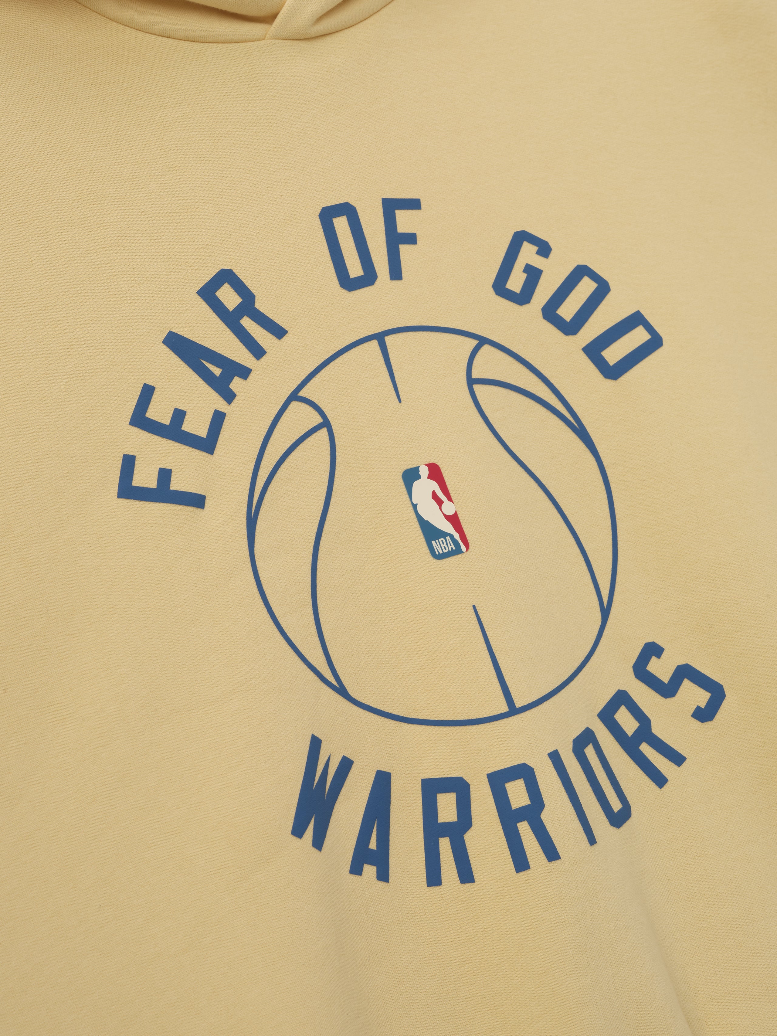 beige hoodie with puff-printed Fear of God Warriors text and outlined NBA basketball graphic on front center