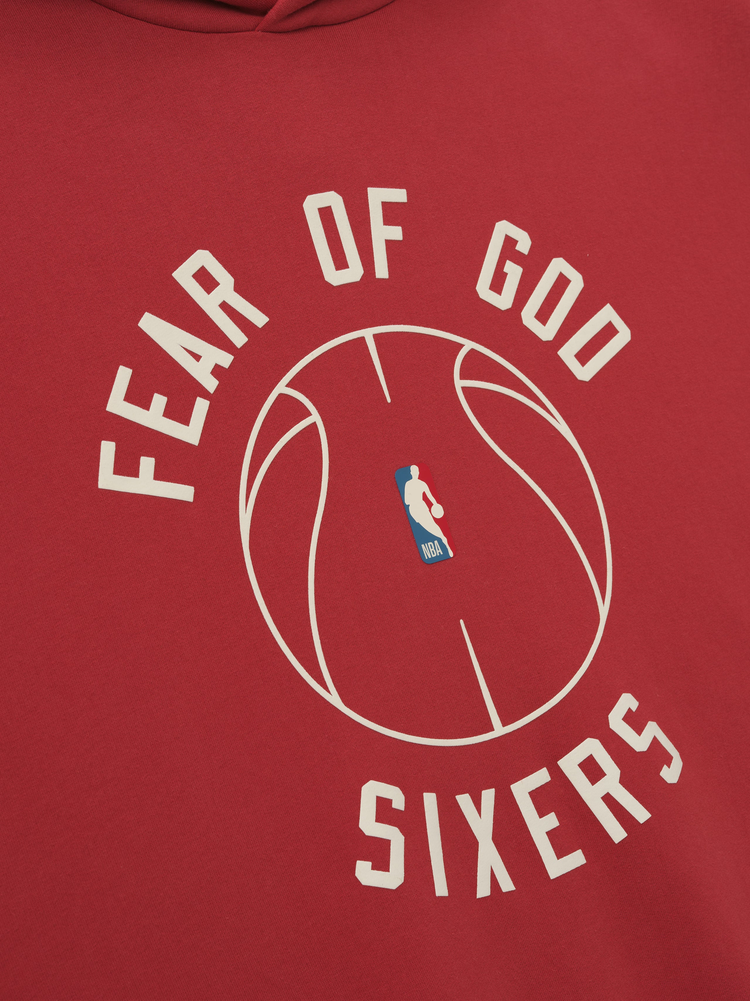 red heavyweight hoodie with puffed FEAR OF GOD SIXERS text surrounding minimalistic basketball outline on front center
