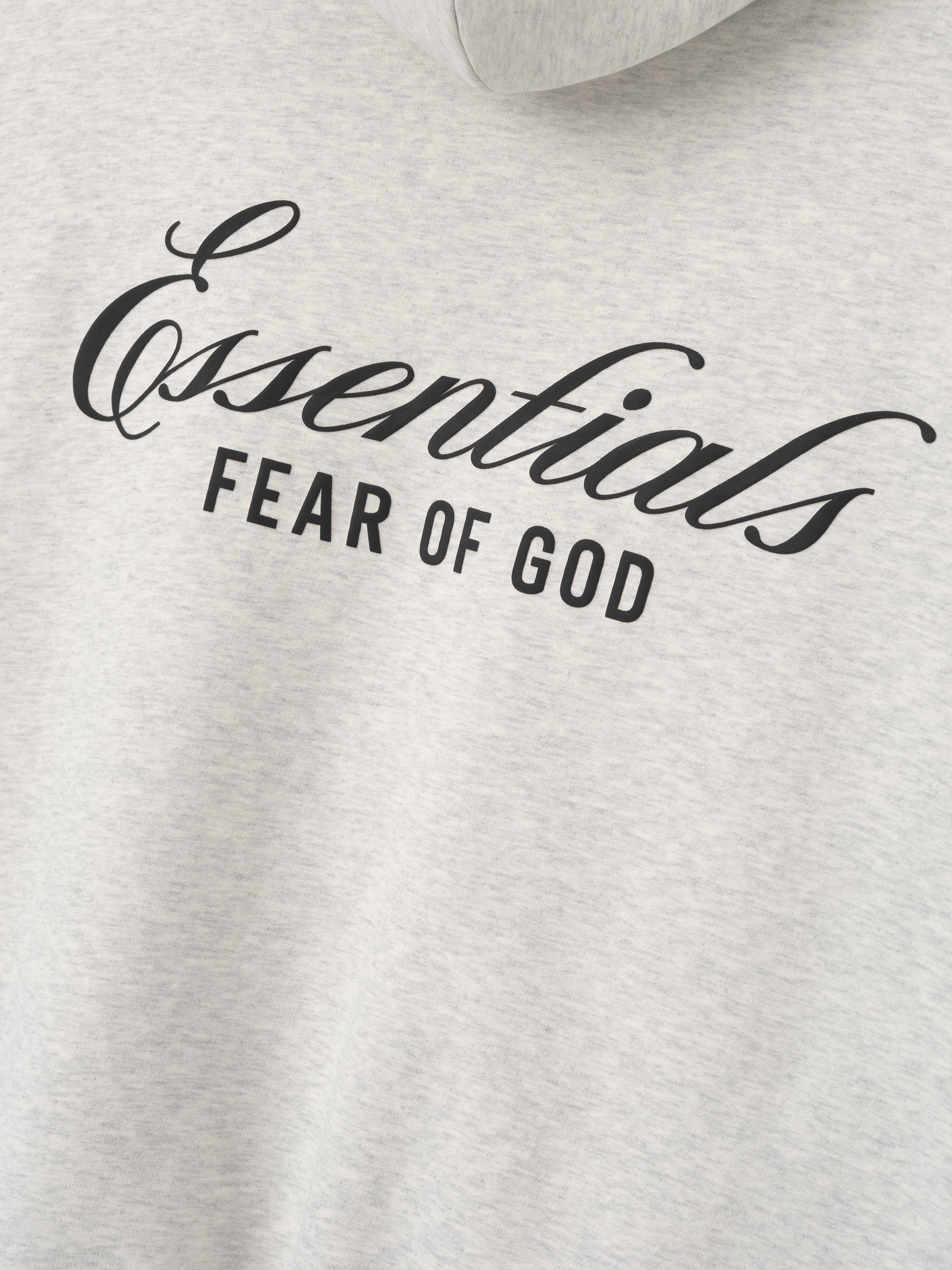 light gray heavyweight cotton fleece hoodie with black Essentials Fear of God scripted logo on chest center