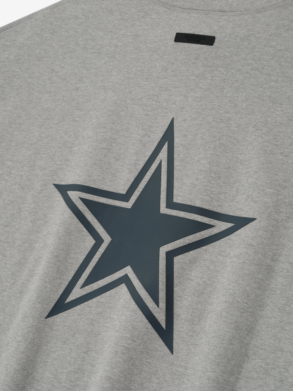 Close-up of concrete heather Cowboys 90s 3/4 Sleeve Football Tee showing large outlined star graphic on fabric