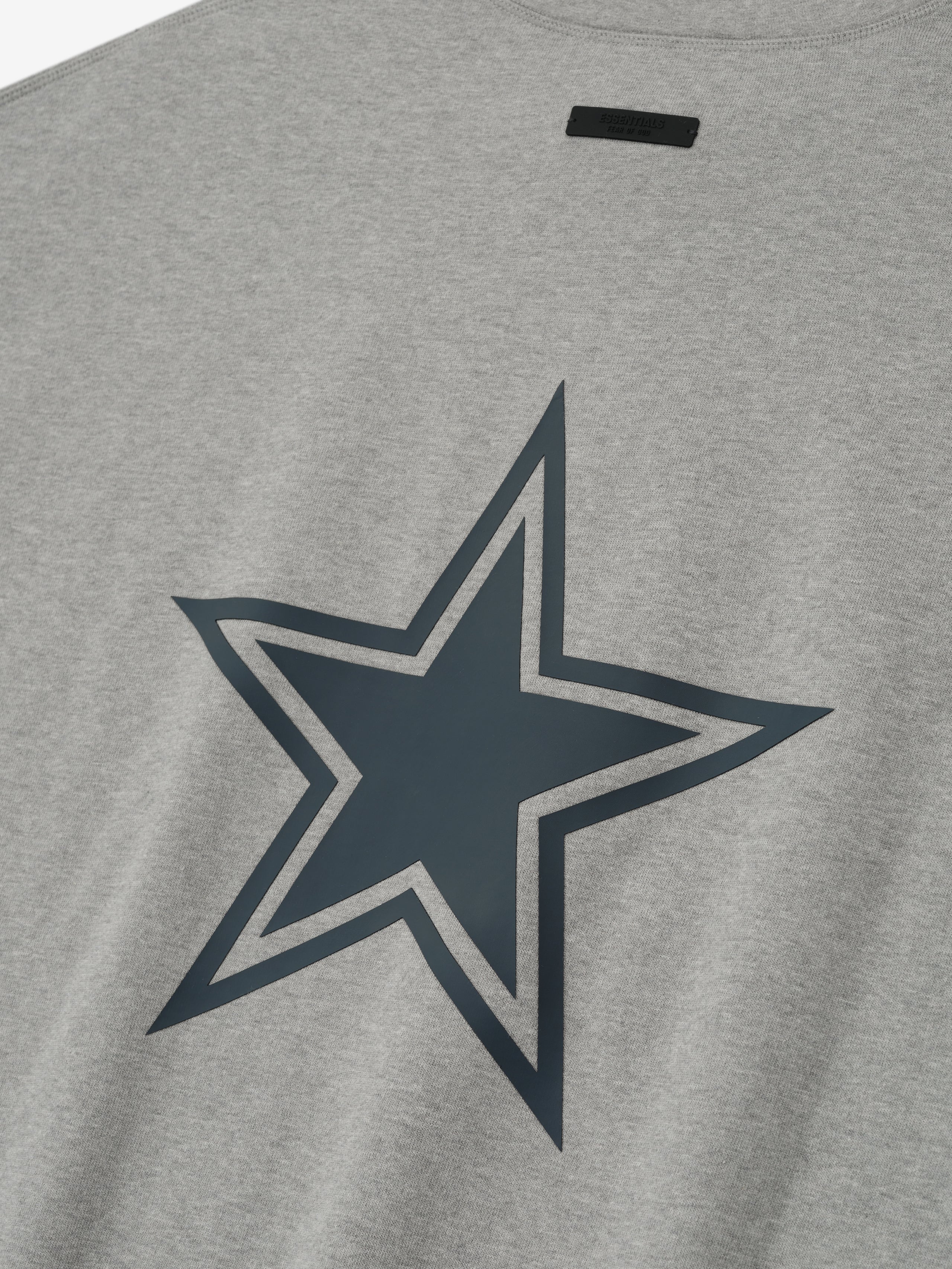Close-up of concrete heather Cowboys 90s 3/4 Sleeve Football Tee showing large outlined star graphic on fabric