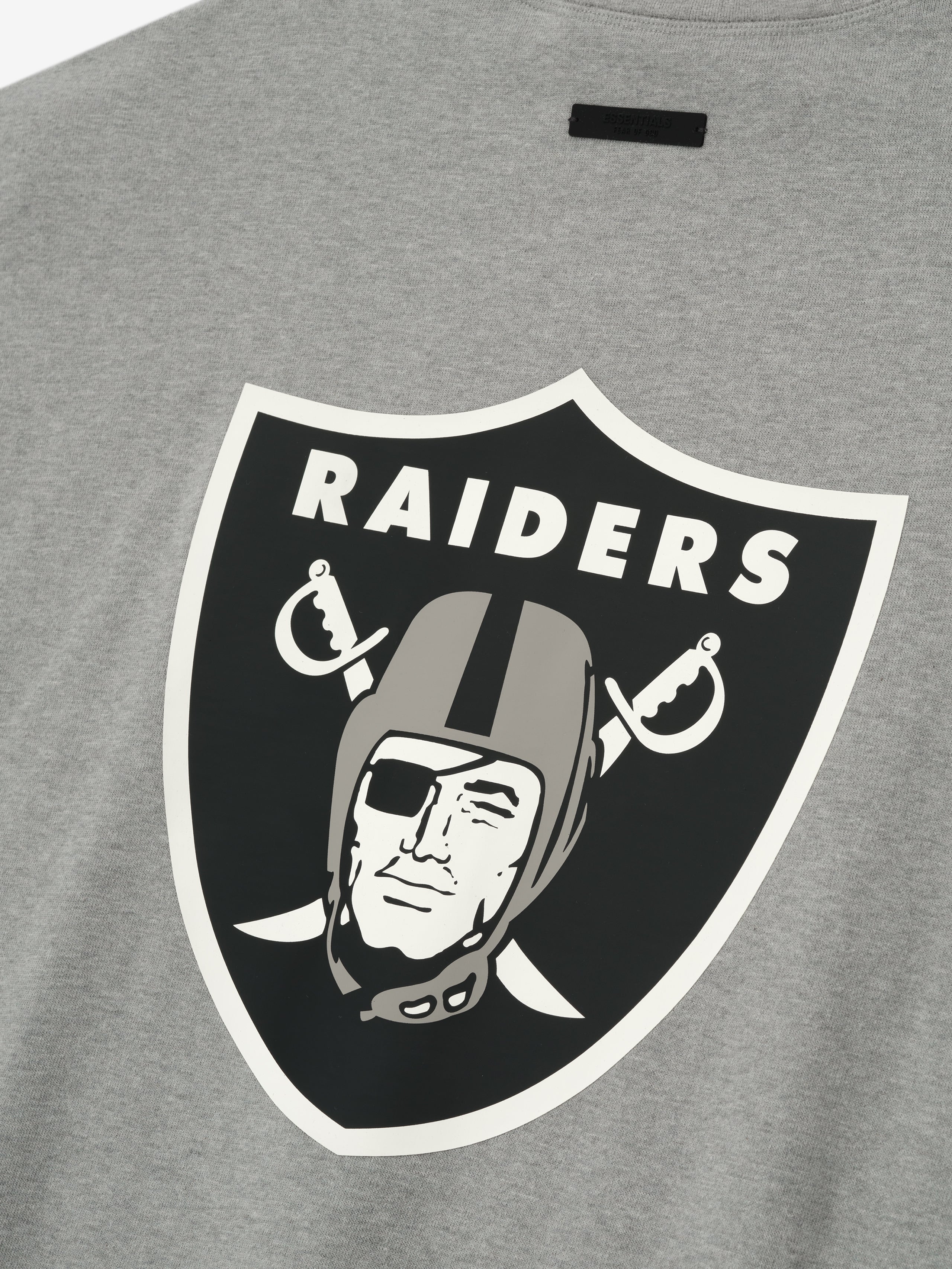 Close-up of concrete heather Raiders 90s 3/4 Sleeve Football Tee showing large classic Raiders shield logo on back center