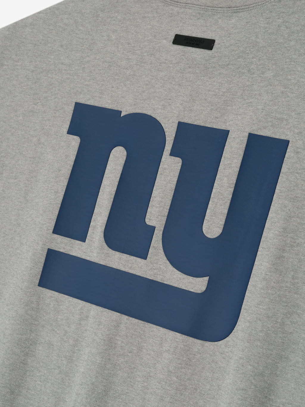 Close-up of concrete heather Giants 90s 3/4 Sleeve Football Tee showing large navy NY logo on front center