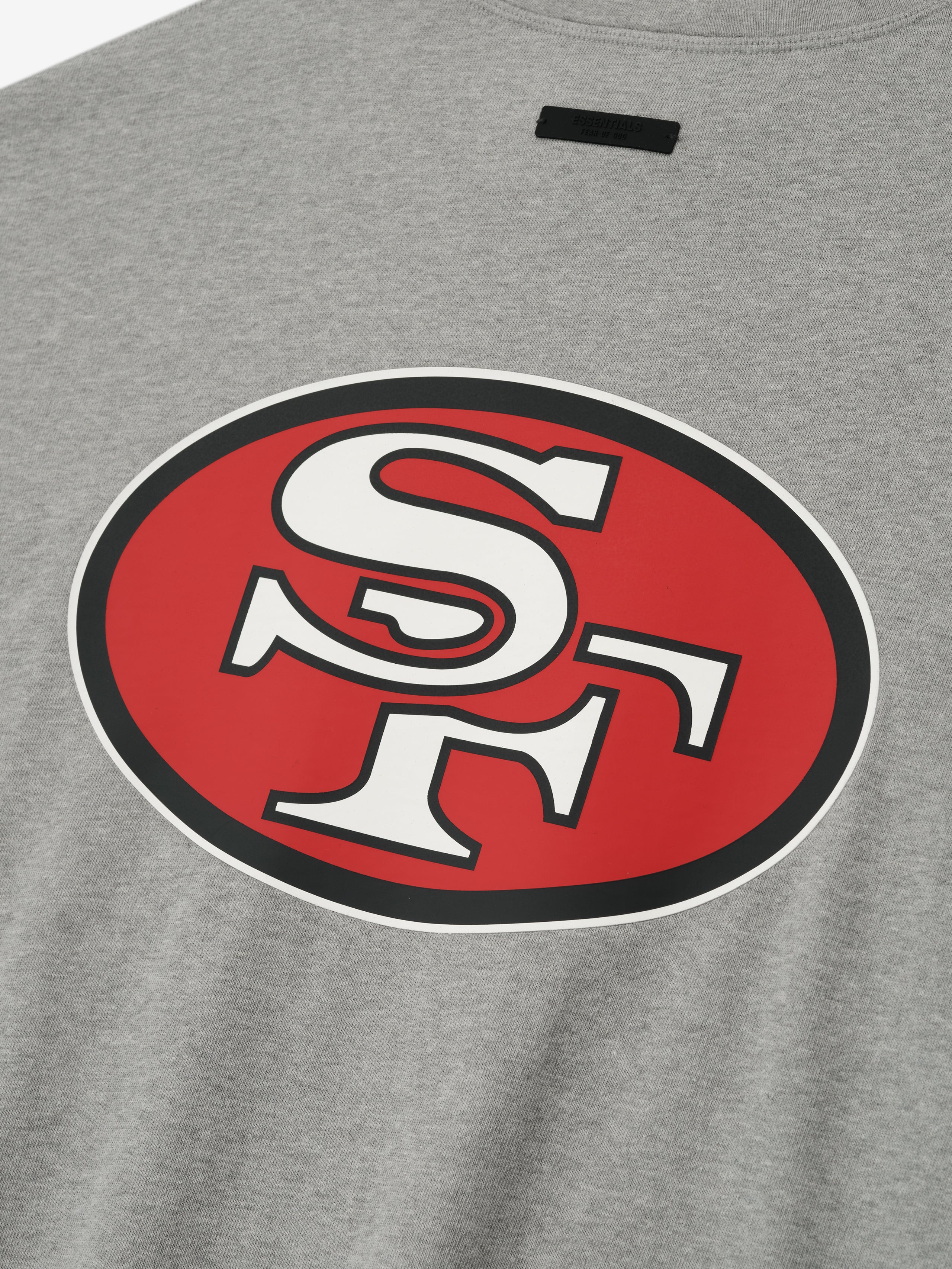 Close-up of concrete heather Forty Niners 90s 3/4 Sleeve Football Tee showing large red and white SF logo on chest