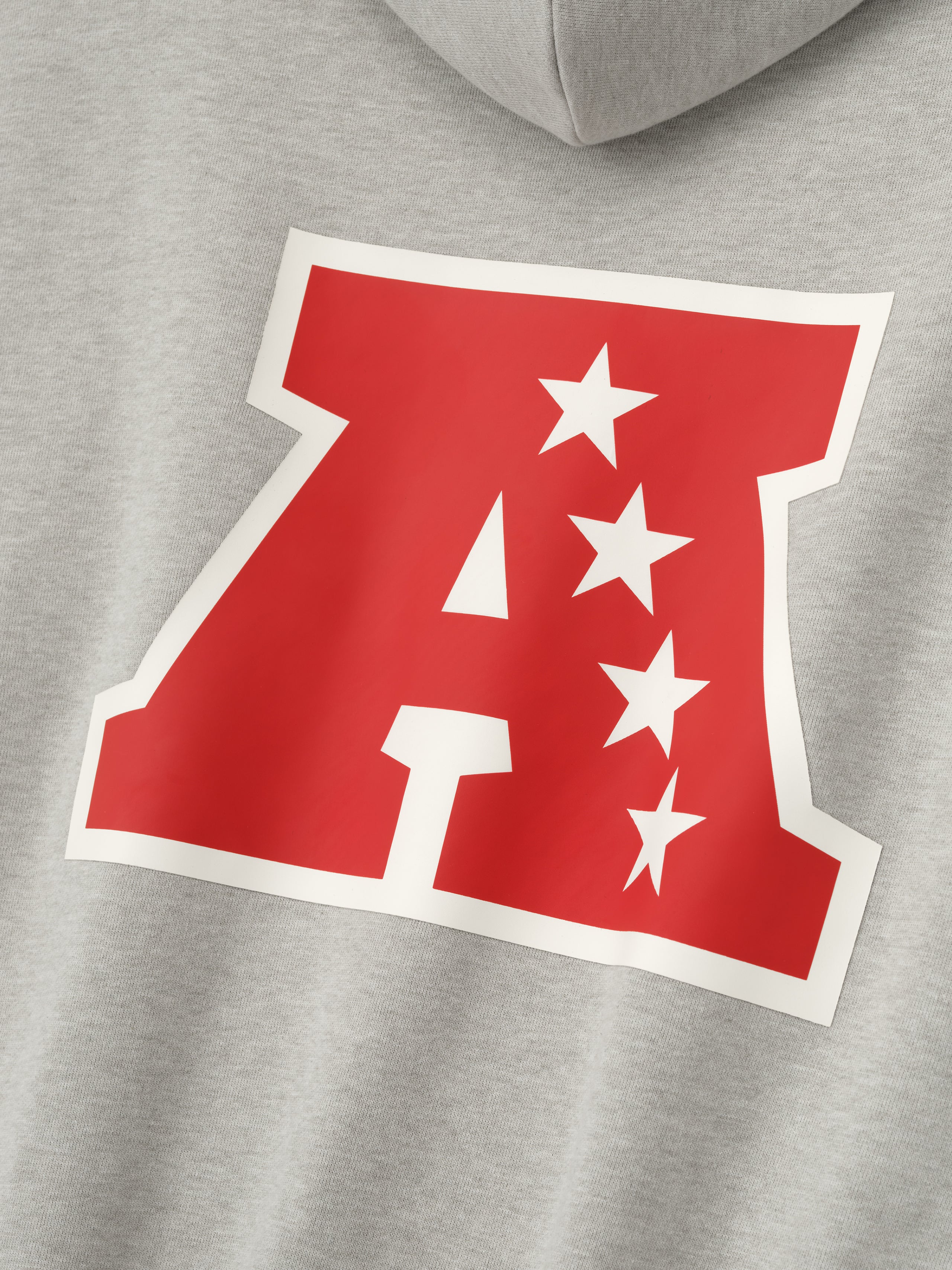 Close-up of heather stone American Sport Hoodie showcasing large red outlined A with four white stars on back panel