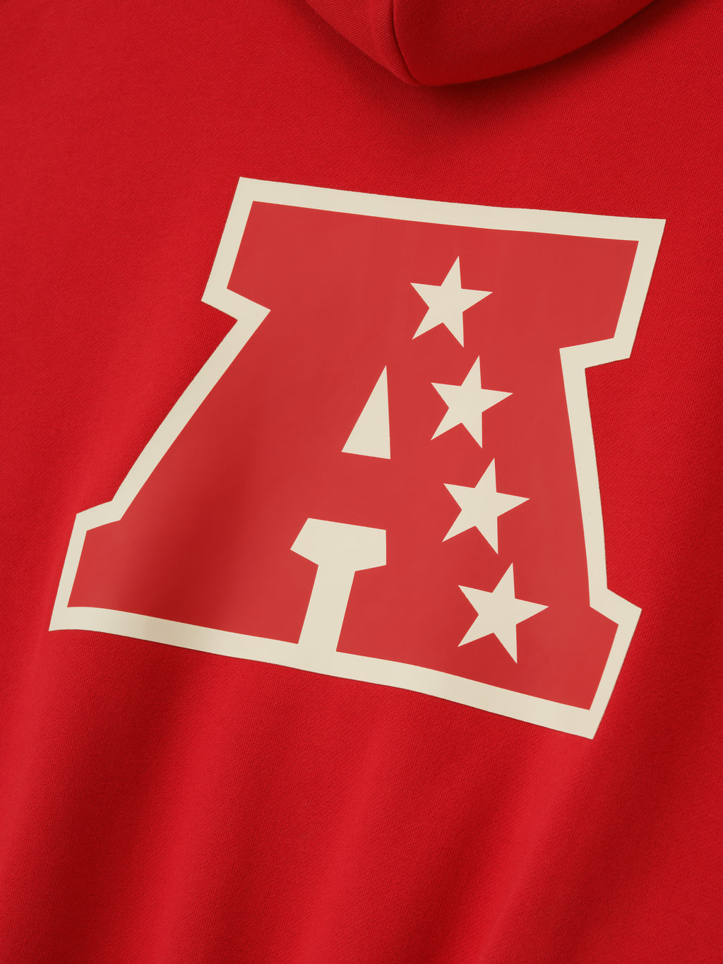 Close-up of red American Sport Hoodie highlighting large outlined letter A with four cream stars on the back panel