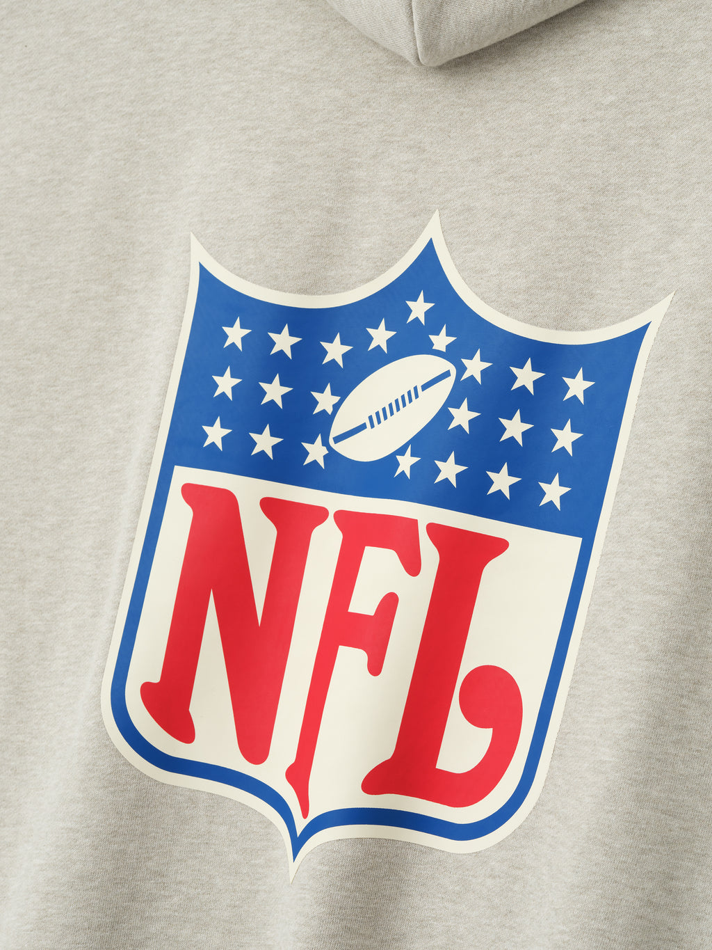 Close-up of heather stone NFL Sport Hoodie showing vintage style NFL logo with red lettering and blue star details, gallery image 0