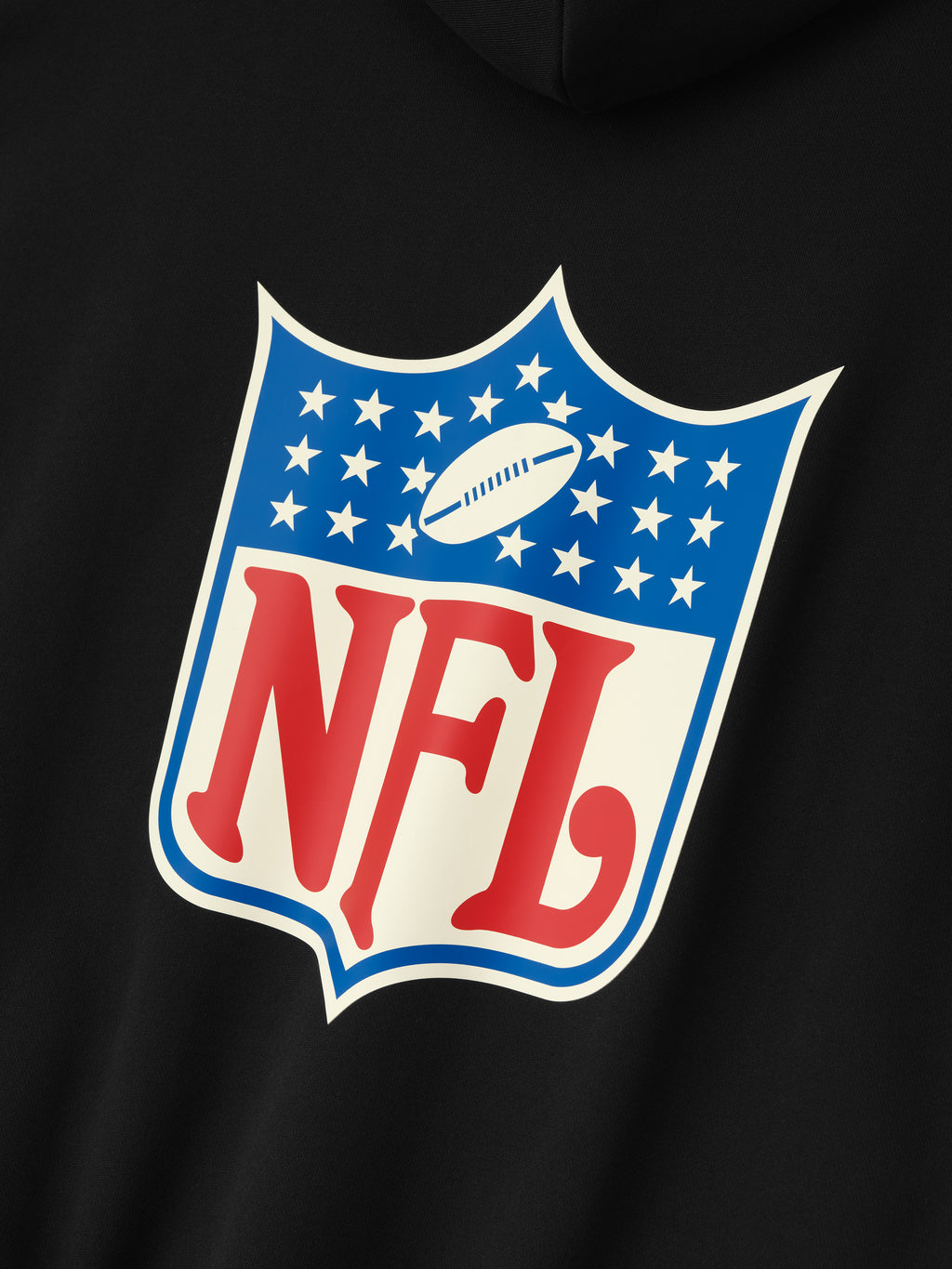 Close-up of black NFL Sport Hoodie showing vintage NFL shield logo in red and blue on the back panel