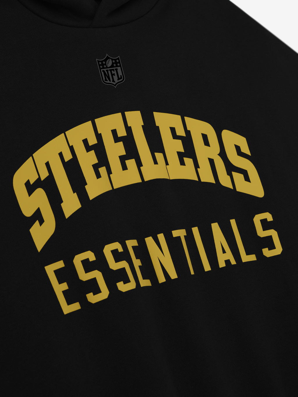 Close-up of black Steelers Sport Hoodie showing gold Steelers Essentials text and subtle black NFL logo above center chest