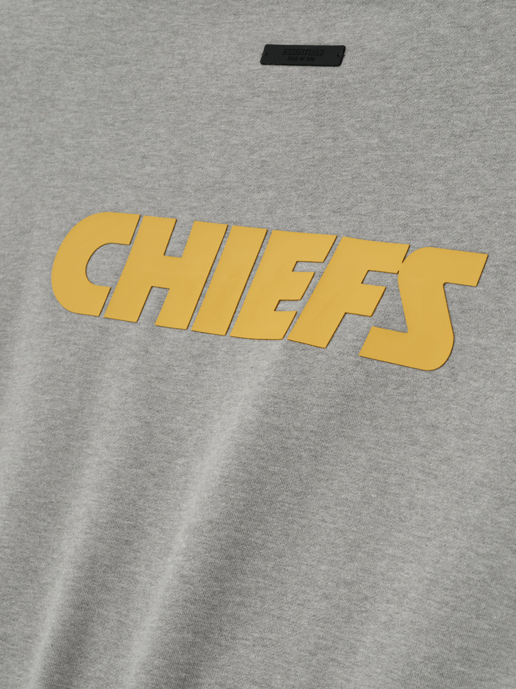 Close-up image of concrete heather Chiefs Sport Crewneck featuring large golden Chiefs text across front, gallery 0