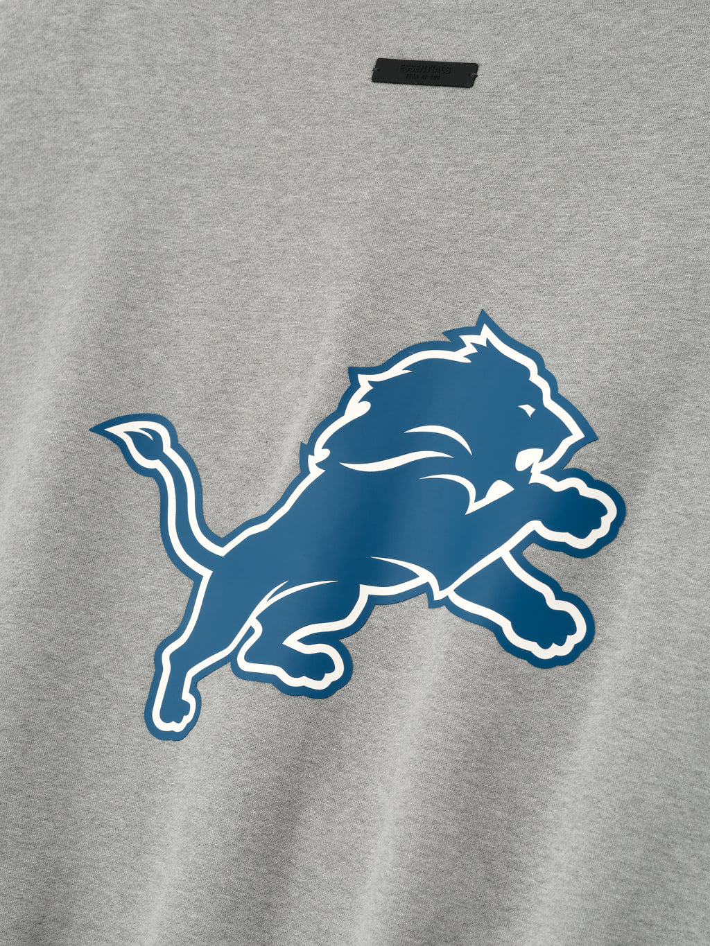 Close-up of concrete heather Lions Sport Crewneck showing large blue Detroit Lions logo centered on front, gallery 0