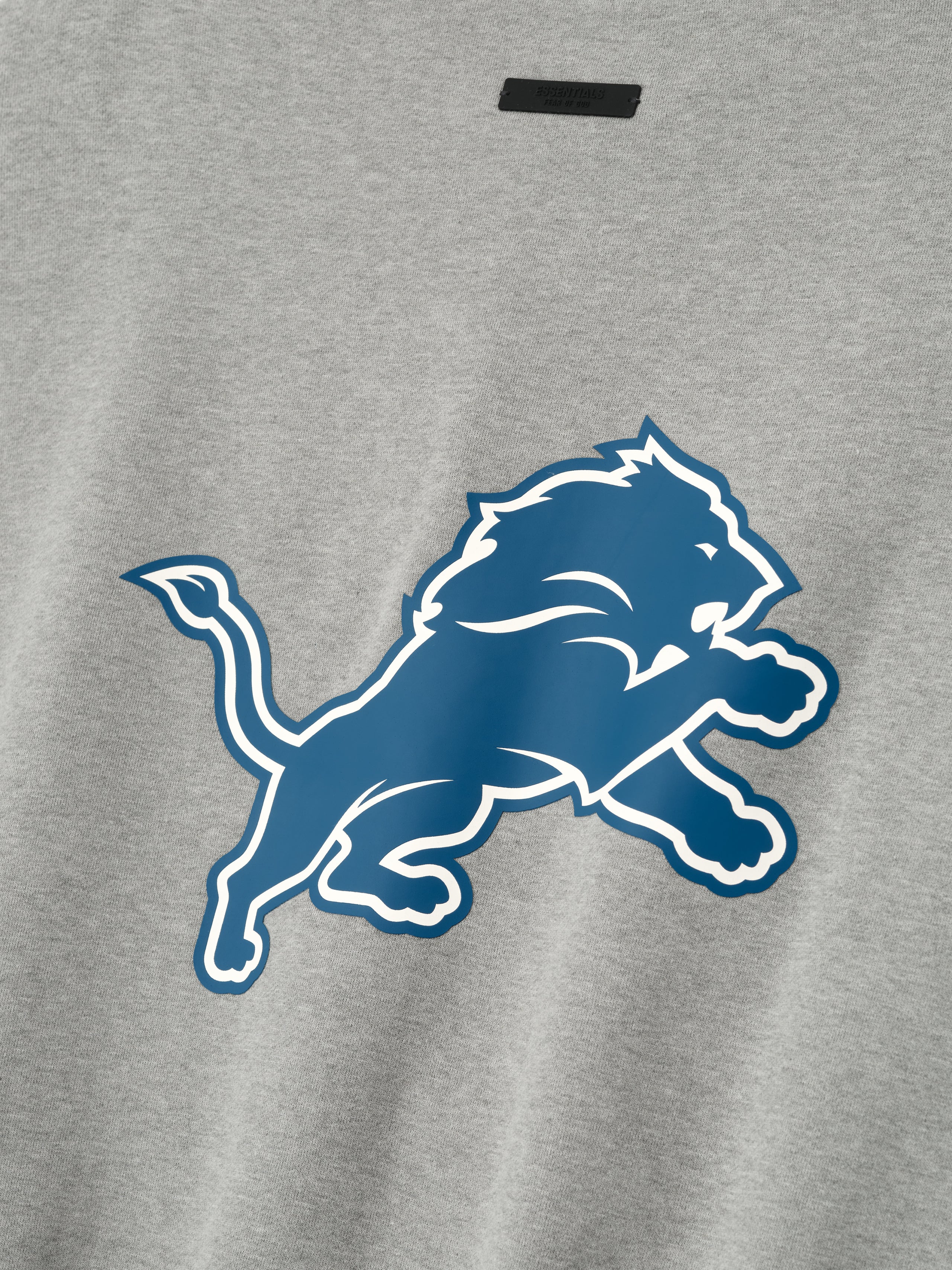 Close-up of concrete heather Lions Sport Crewneck showing large blue Detroit Lions logo centered on front, gallery 0