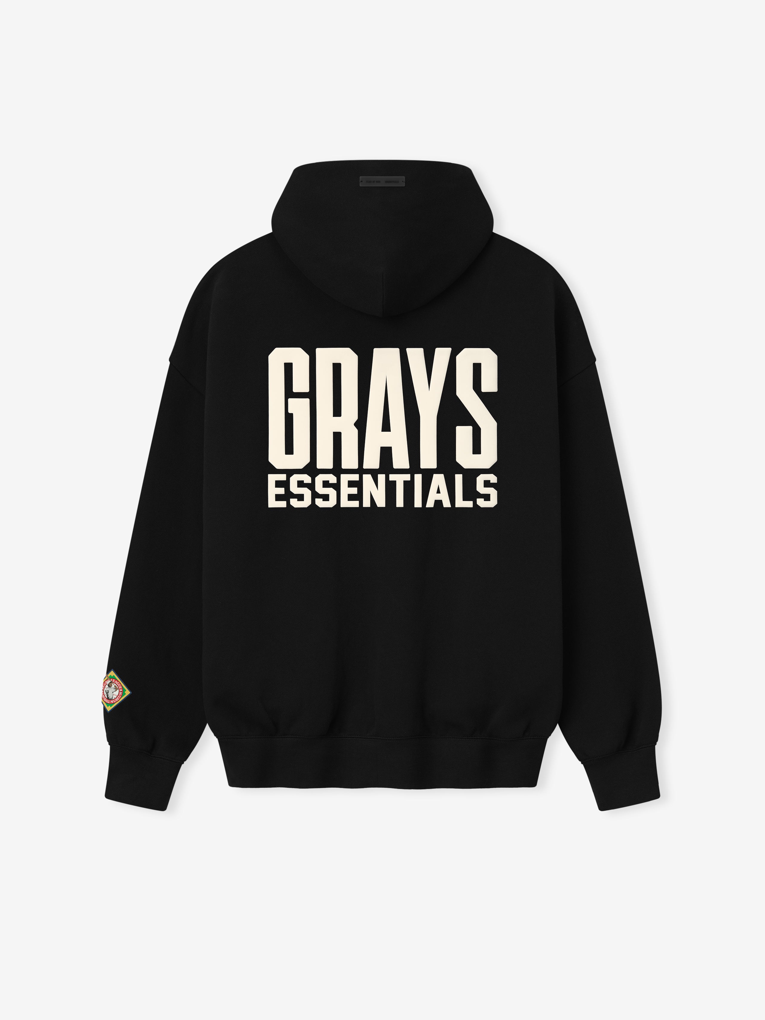 black hoodie with large cream "GRAYS ESSENTIALS" text on back and colorful patch detail on left sleeve cuff