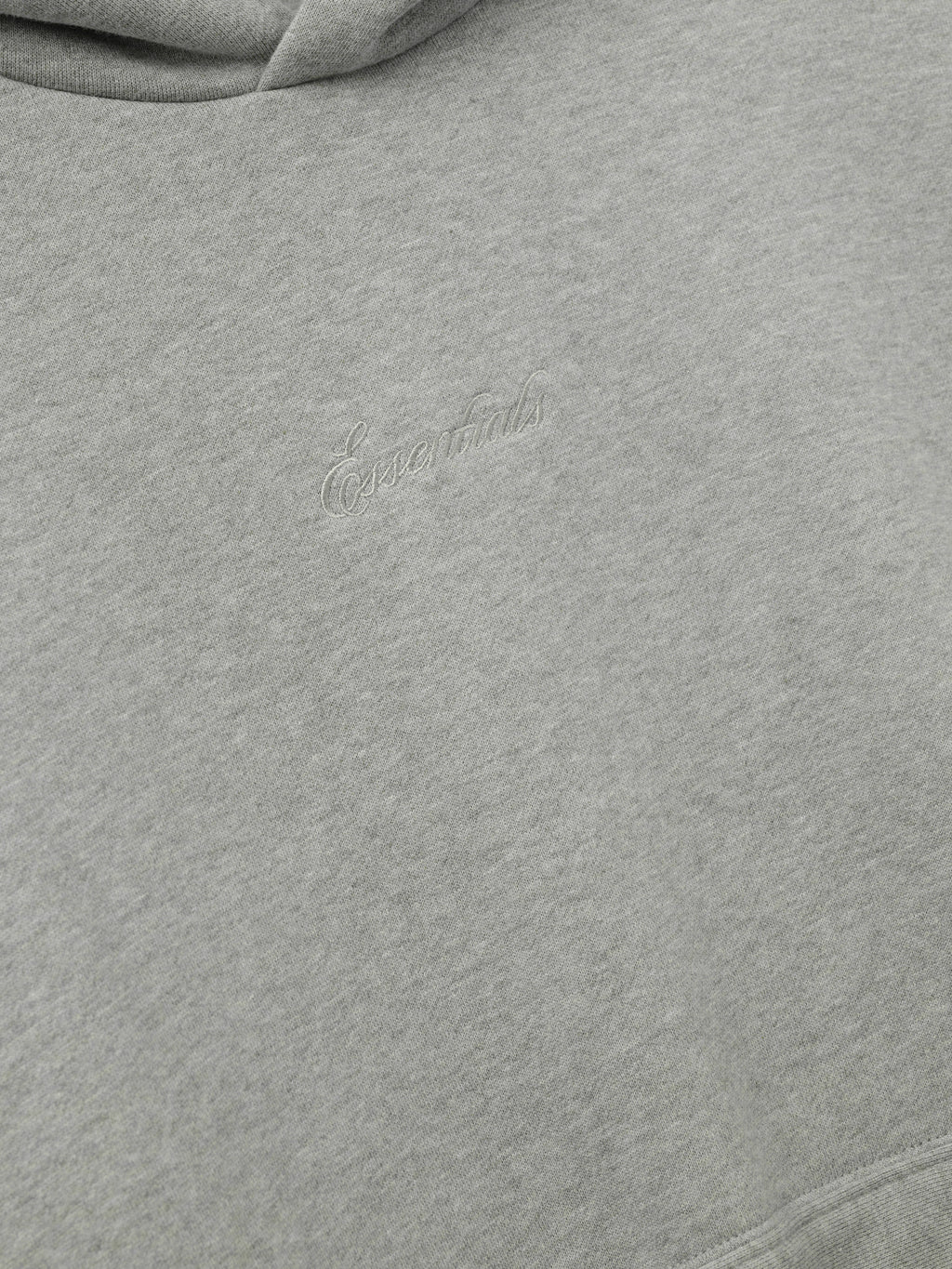 Gray hoodie with essentials embroidery on a white background