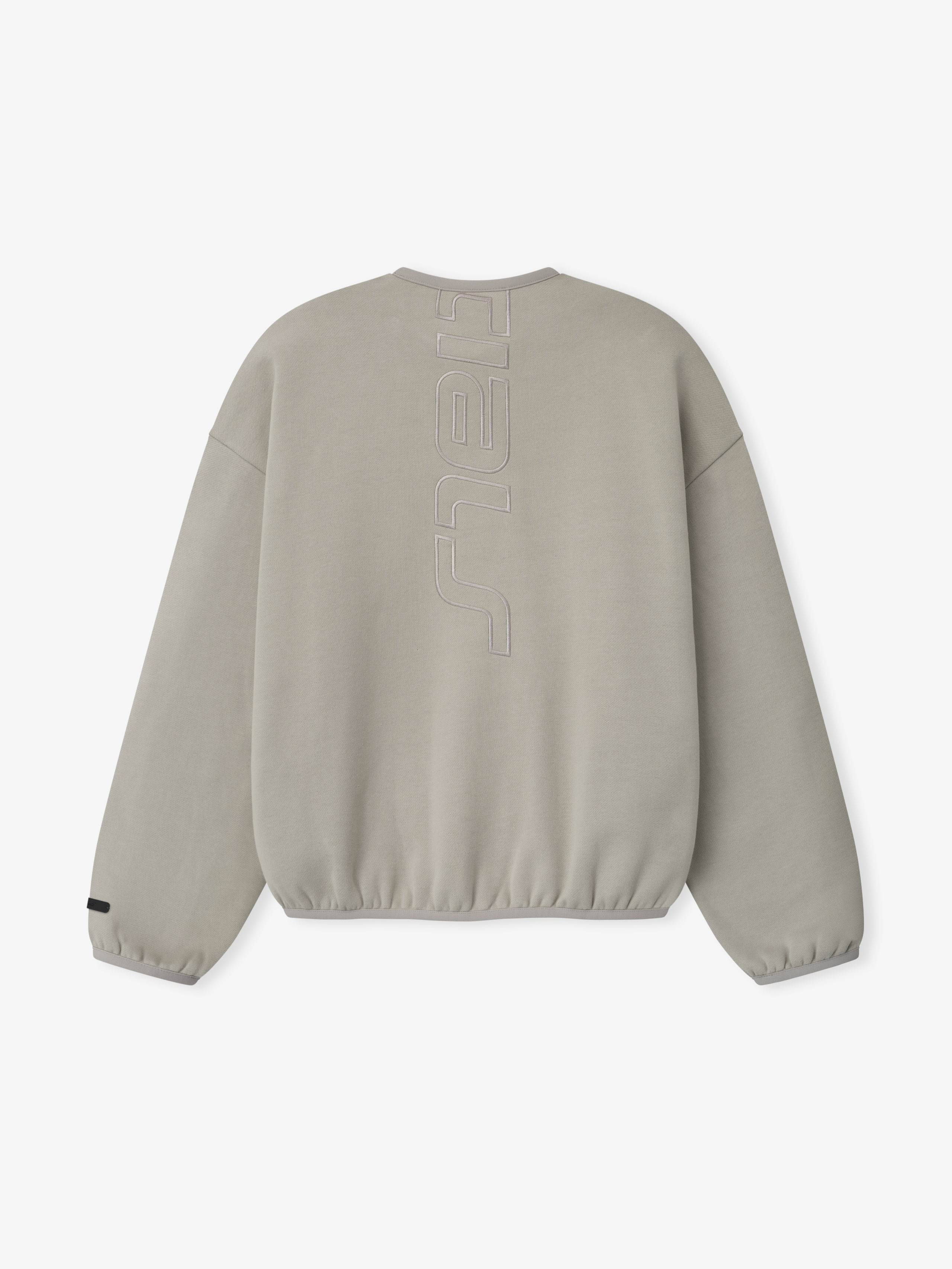 Back view of light taupe sweatshirt with vertical embossed lettering down center and elasticated cuffs and hem