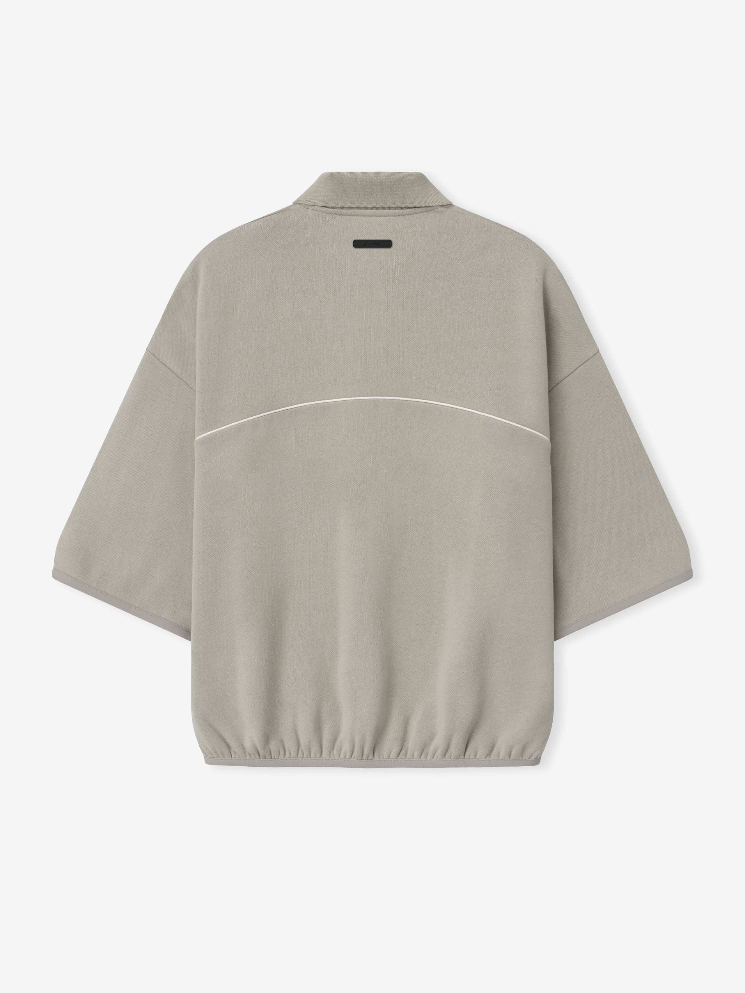 beige cropped modern polo sweatshirt with volume fit, 3/4 sleeves, elastic hem, and subtle white piping across back
