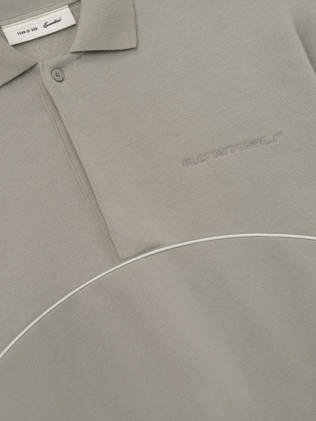 taupe modern polo sweatshirt with volume fit, cropped silhouette, embroidered logo, and curved white piping detail across chest