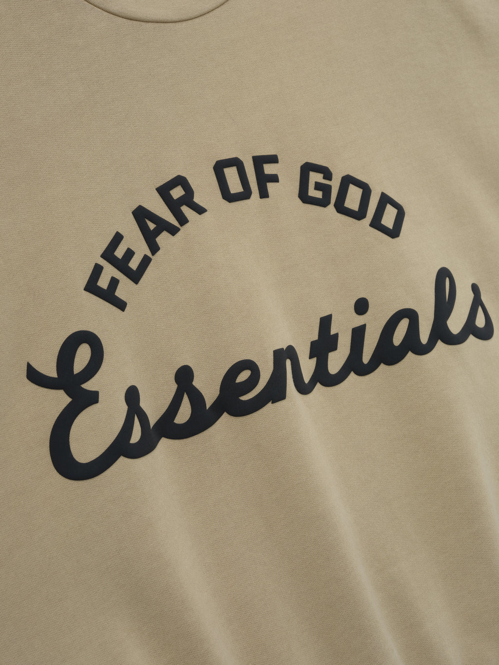 Beige sweatshirt with 'Fear of God Essentials' text in black