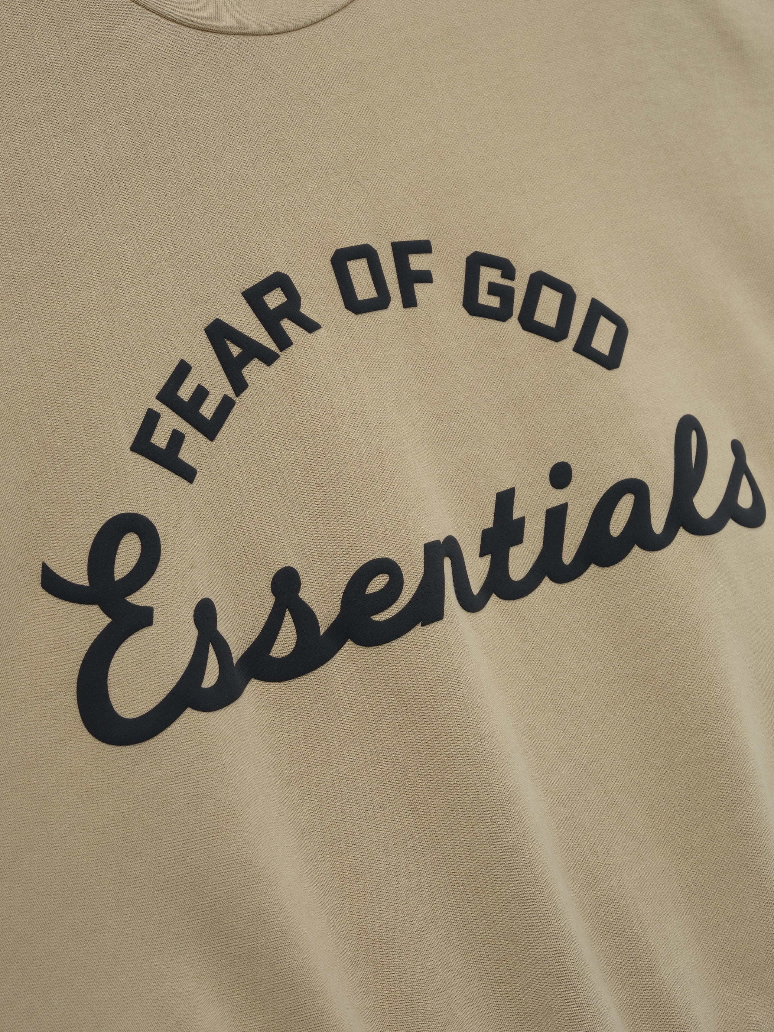 Beige sweatshirt with 'Fear of God Essentials' text in black