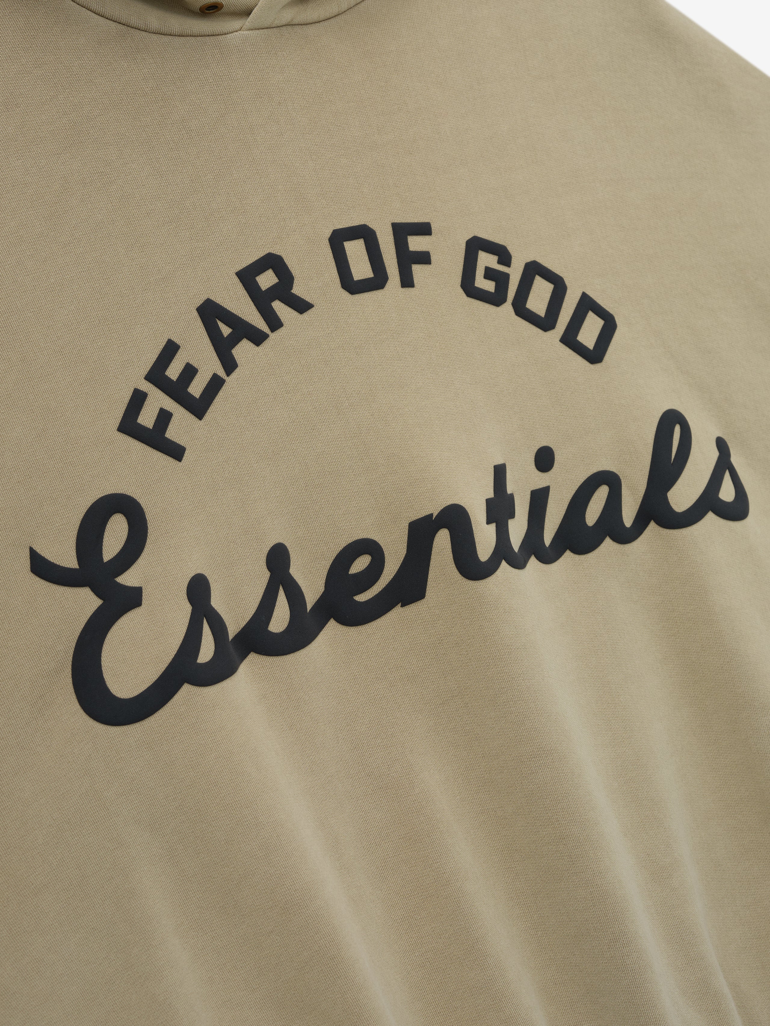 close-up of taupe cotton fleece hoodie with puff-printed Fear of God Essentials training logo on front