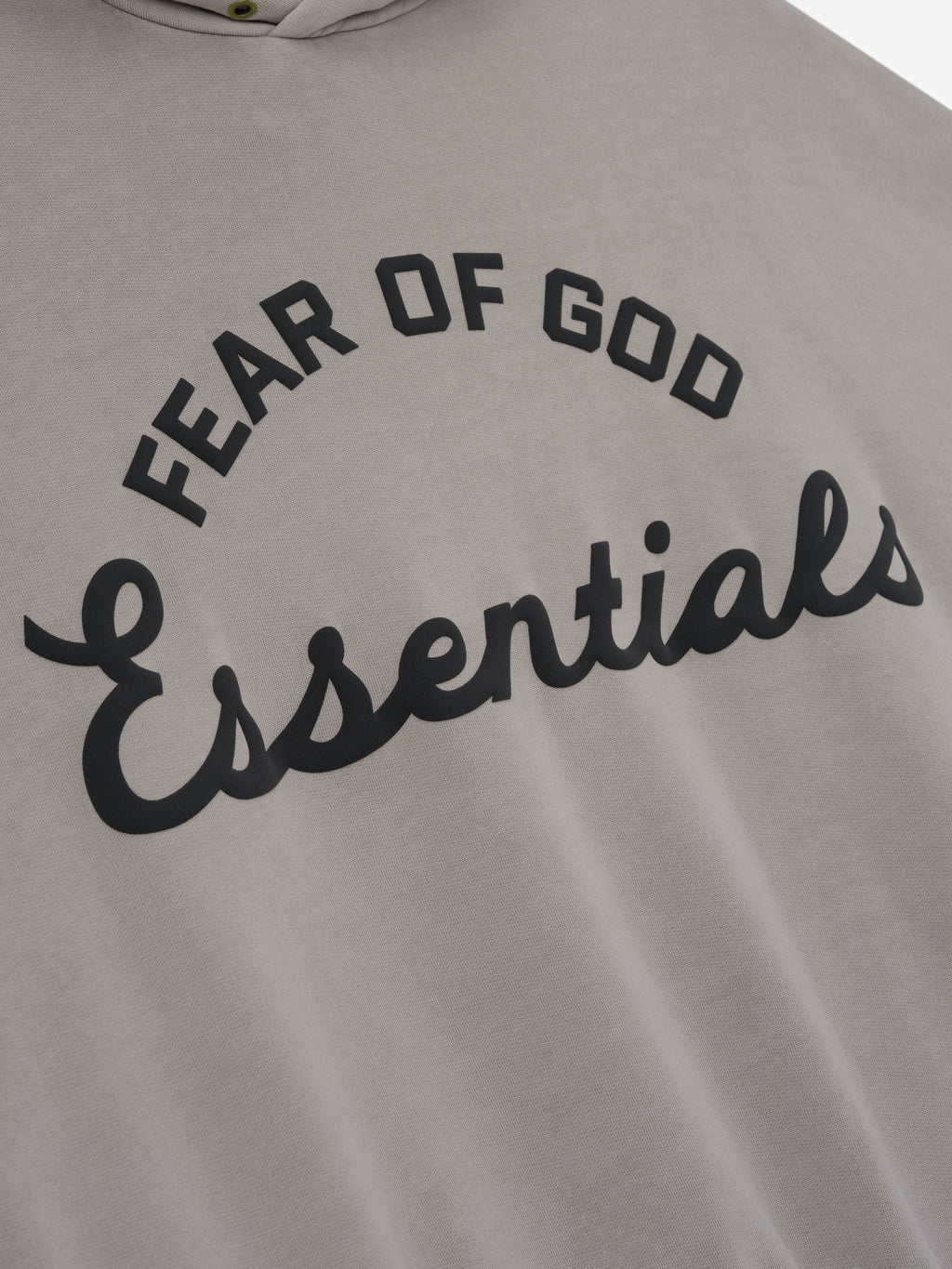 close-up of taupe cotton fleece hoodie with black puff-printed Fear of God Essentials logo on front