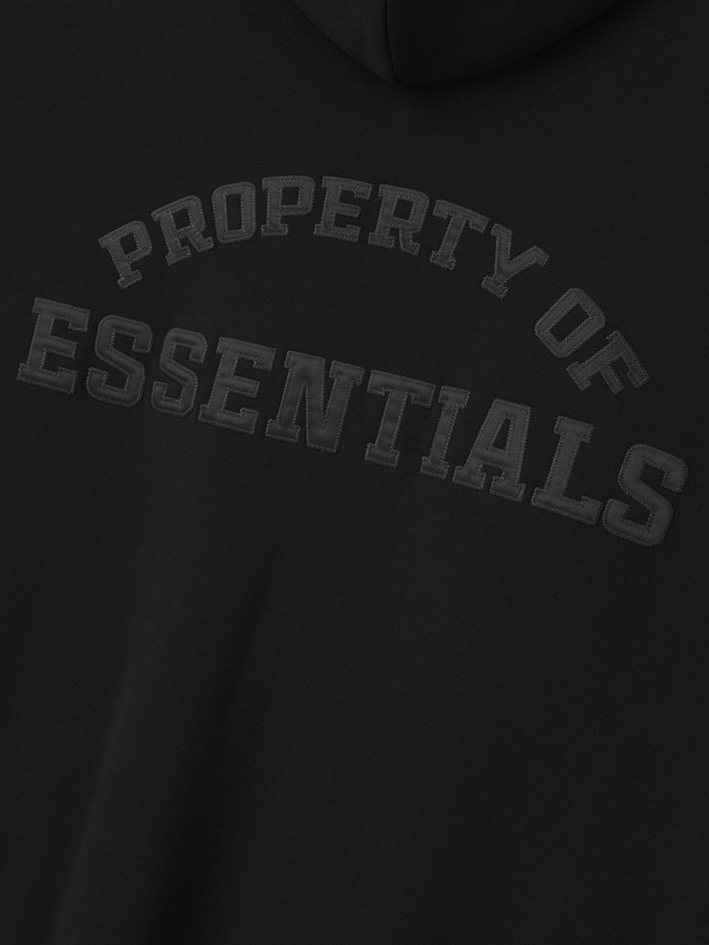 close-up of black heavyweight fleece hoodie with embossed Property of Essentials logo on back panel