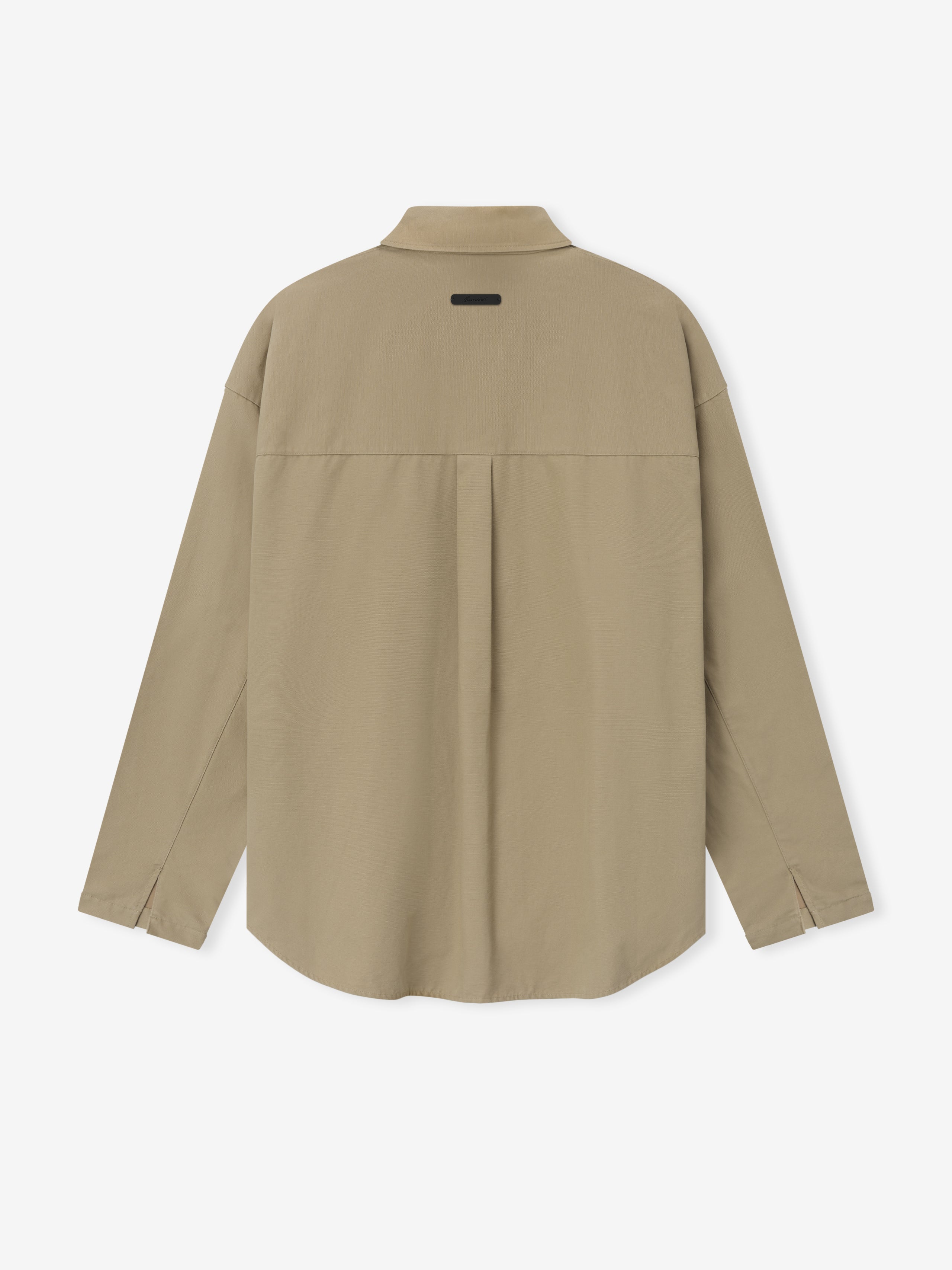 Back view of beige long-sleeve shirt with center pleat and small rectangular patch near collar on plain background