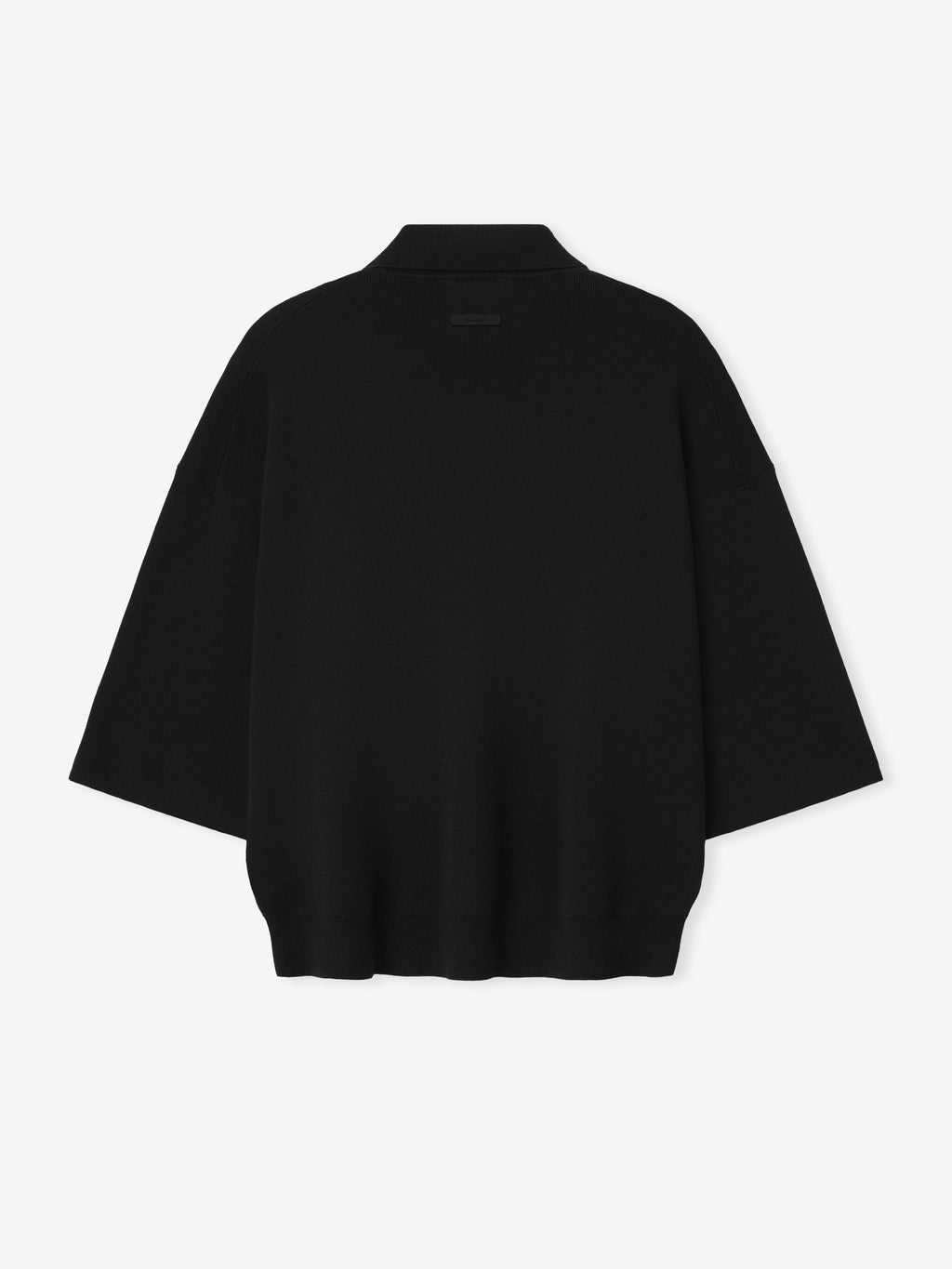 black heavy merino knit polo with relaxed fit and 3/4 sleeves, featuring a subtle signature label on the back neckline