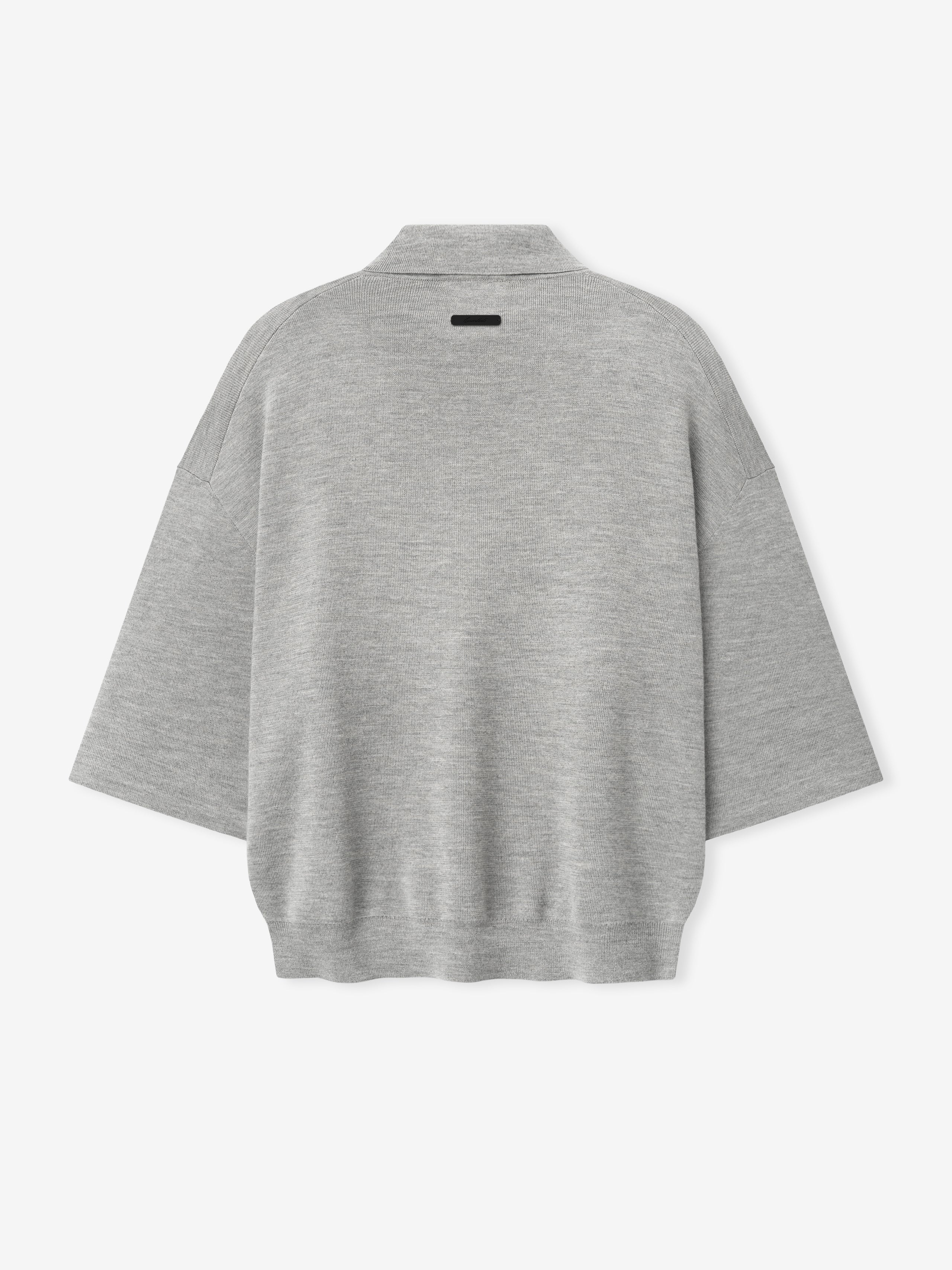 back view of light grey heavy merino knit polo with 3/4 sleeves and relaxed fit featuring small black label on neckline