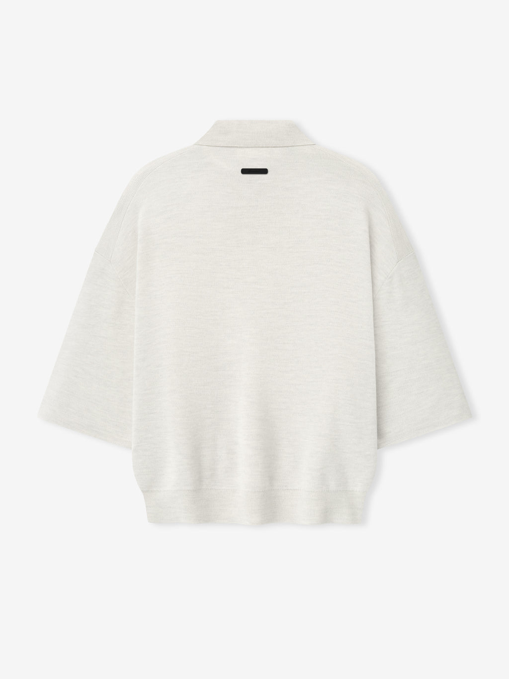 back view of off-white heavy merino knit polo with 3/4 sleeves and relaxed fit featuring small black label on neckline