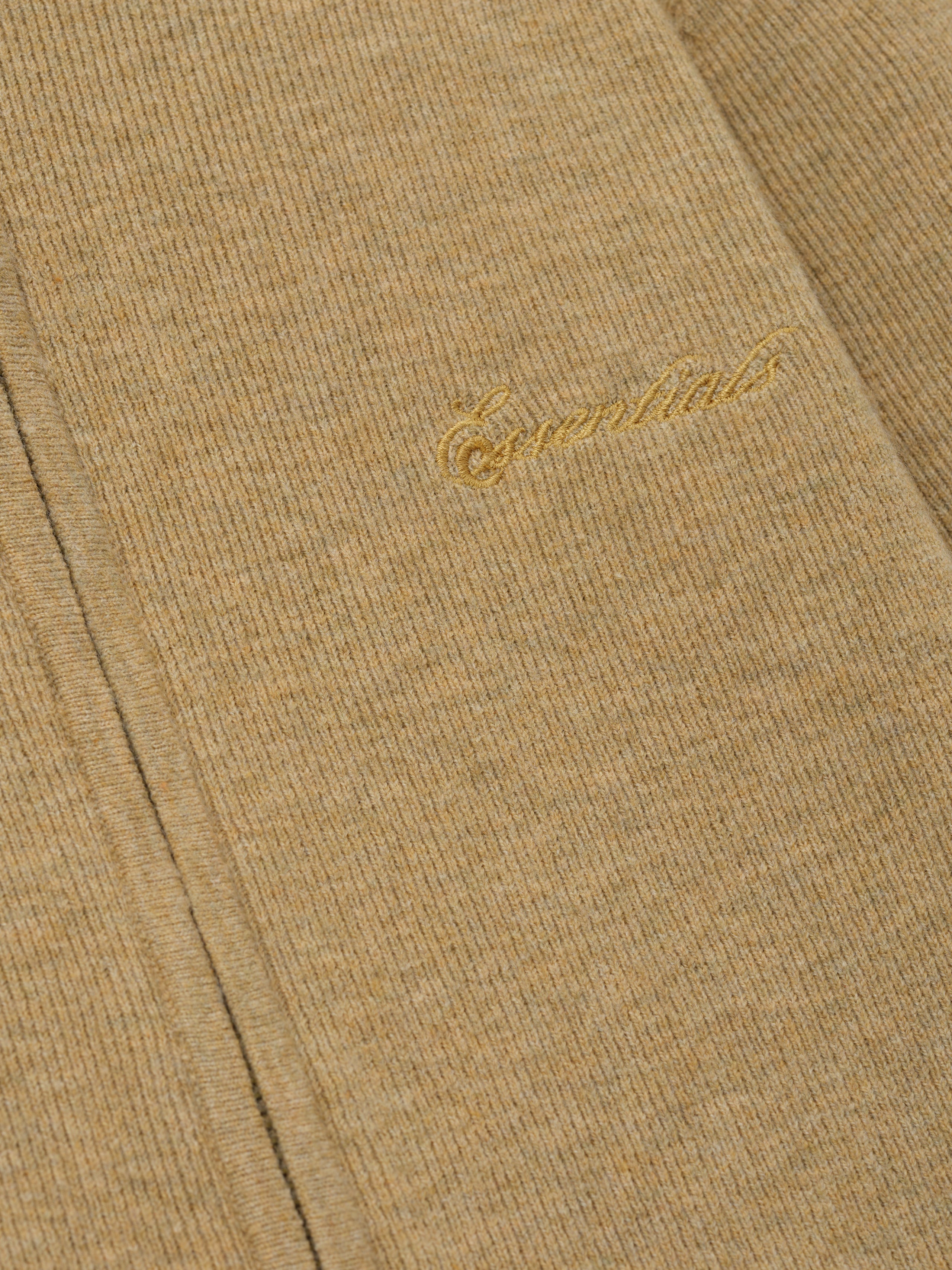 Beige fabric with gold embroidery on a matching beige background