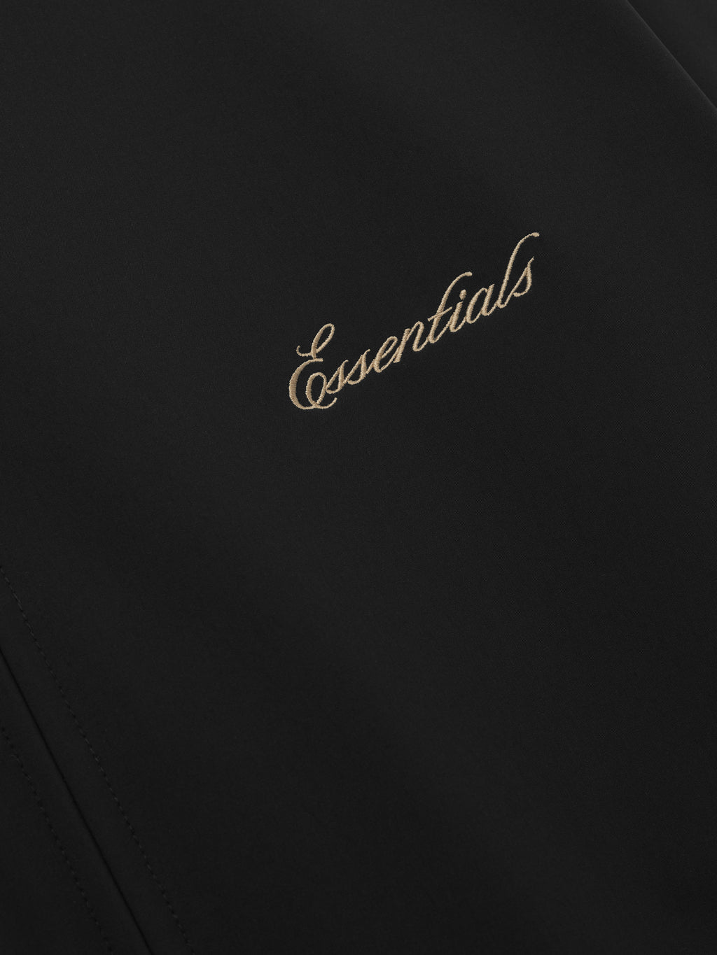 Black fabric with 'Essentials' embroidered 