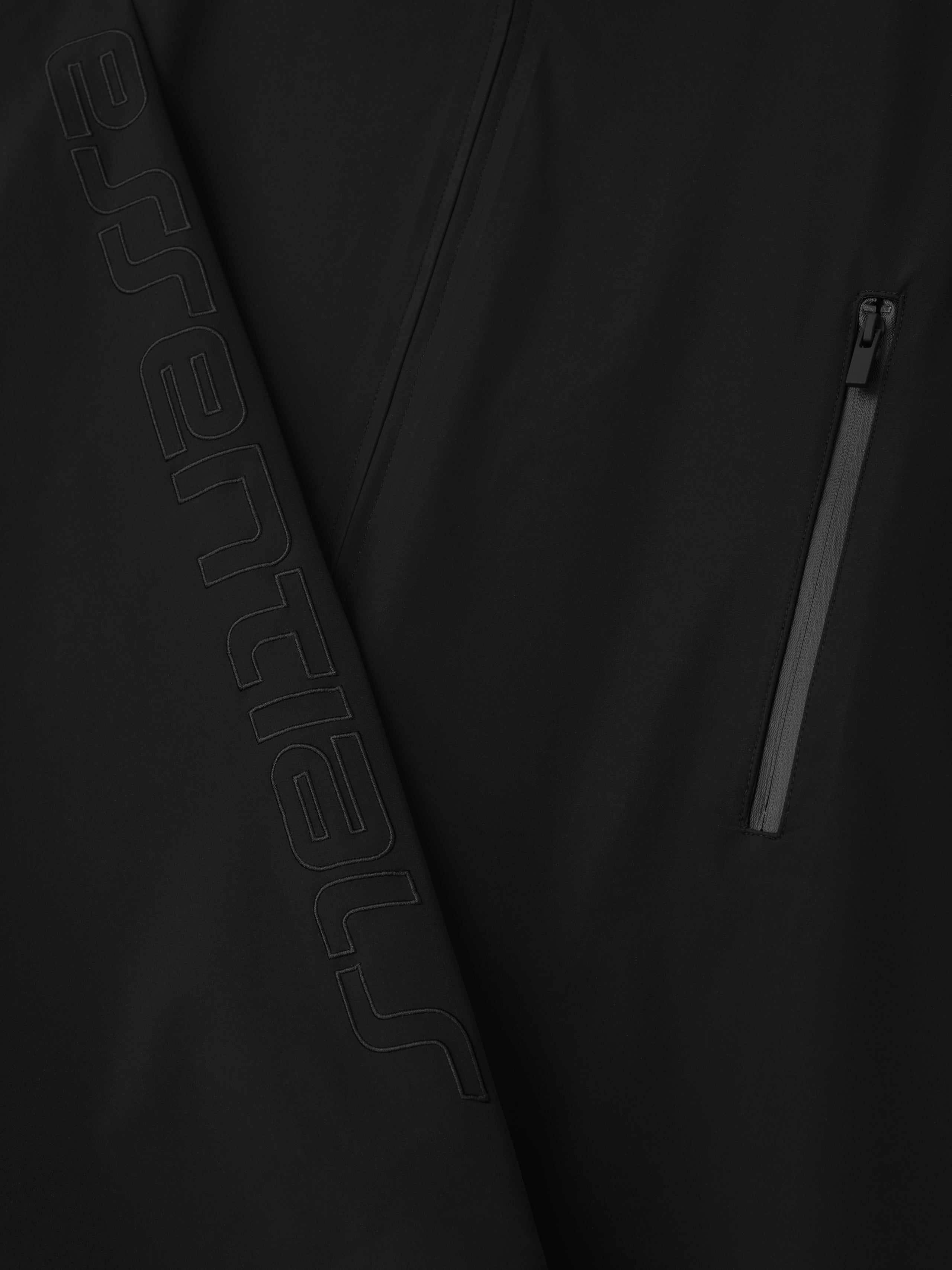 Close-up of a black jacket with a zipper and branding detail.