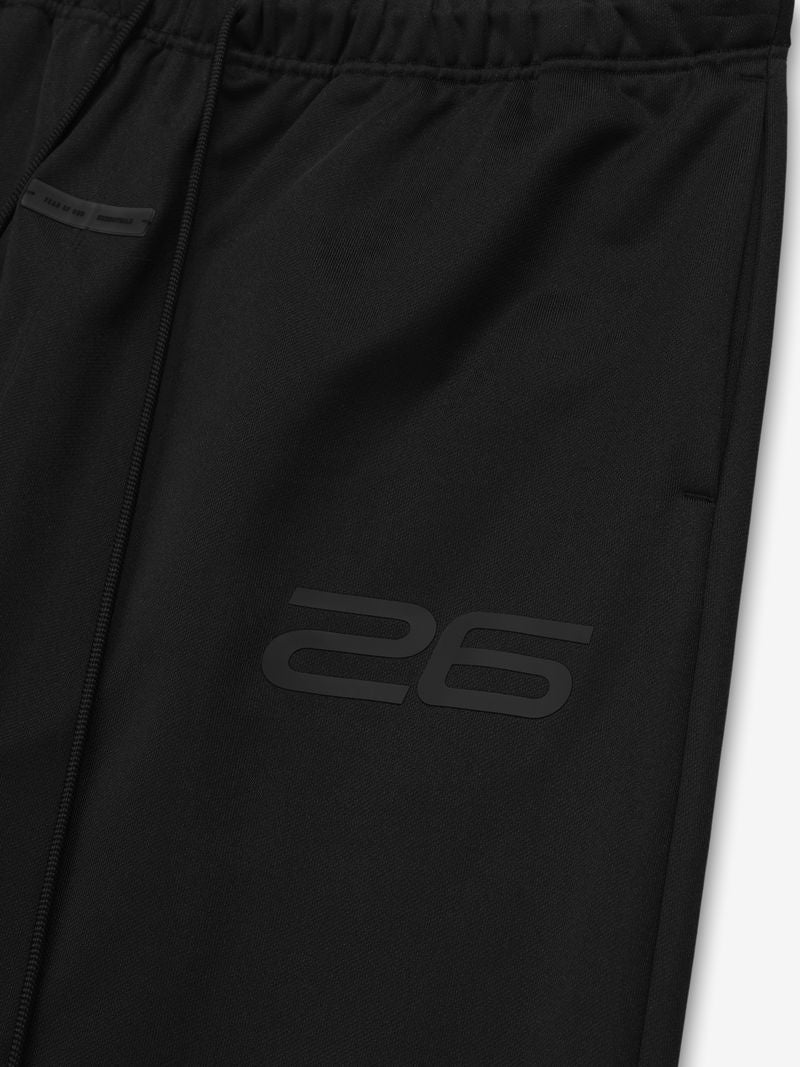 Close-up of black Satin Fleece Lounge Sweatpant featuring elastic waistband, drawstrings, and subtle tonal "26" print detail.