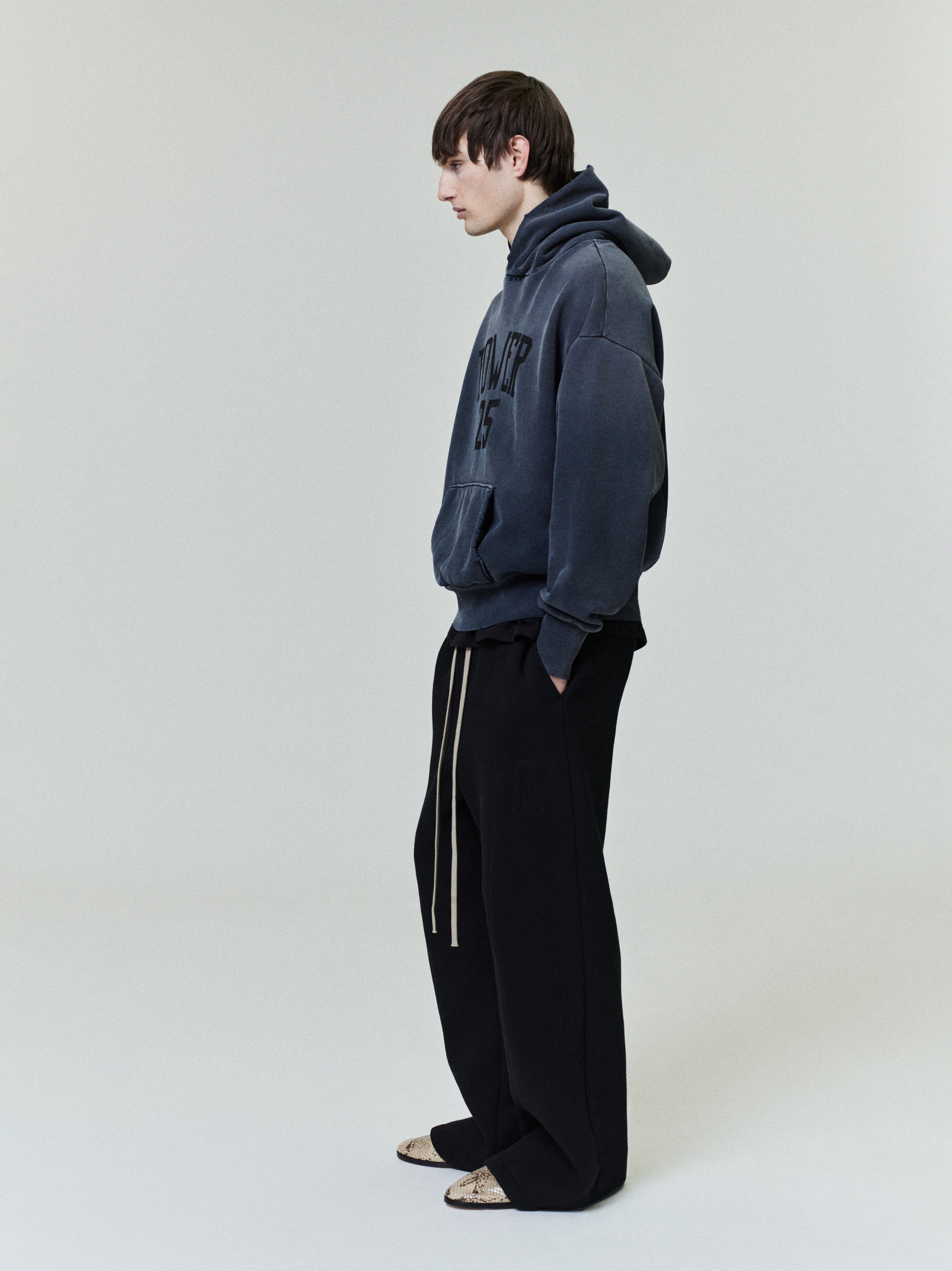 Vintage Power 25 Hoodie in washed charcoal gray featuring raised textured lettering on the chest, styled as a relaxed outerwear top with a cozy oversized fit.