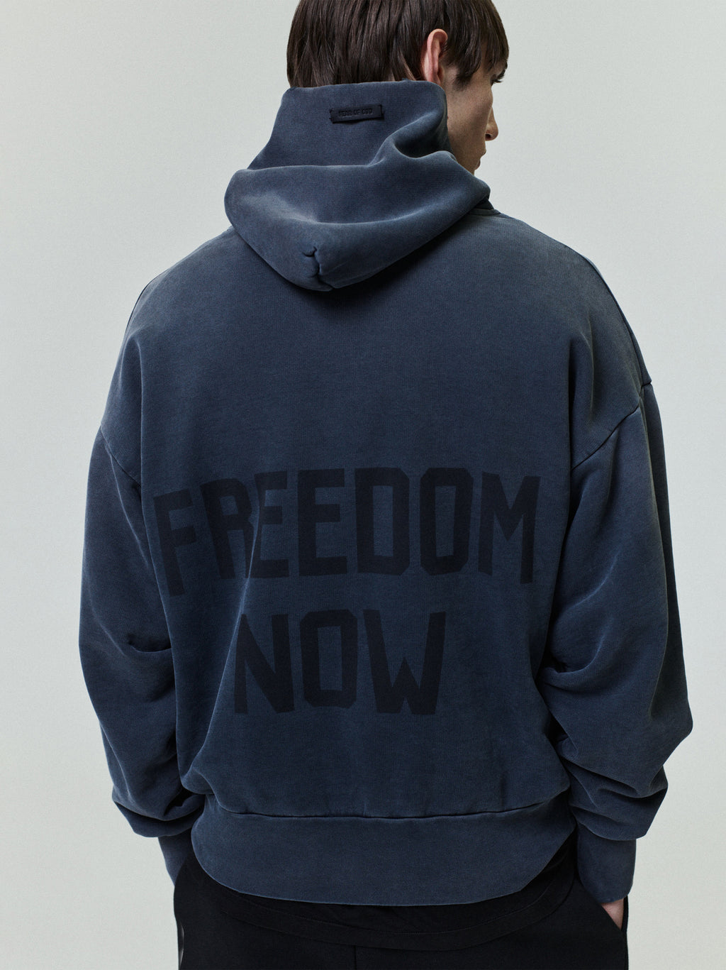 Vintage Power 25 Hoodie in washed navy blue with bold "FREEDOM NOW" text printed on the back, crafted from soft fabric for a relaxed and comfortable outerwear style.