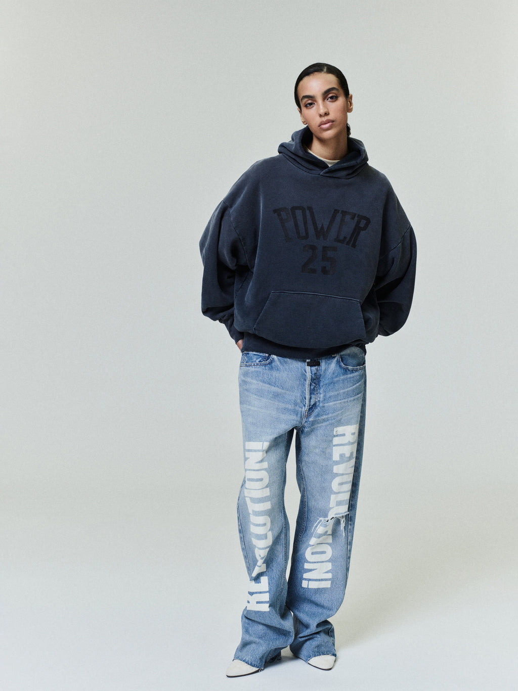 Vintage Power 25 Hoodie in washed navy featuring a relaxed oversized fit and bold textured "POWER 25" text on the front, styled with loose printed denim for casual outerwear.