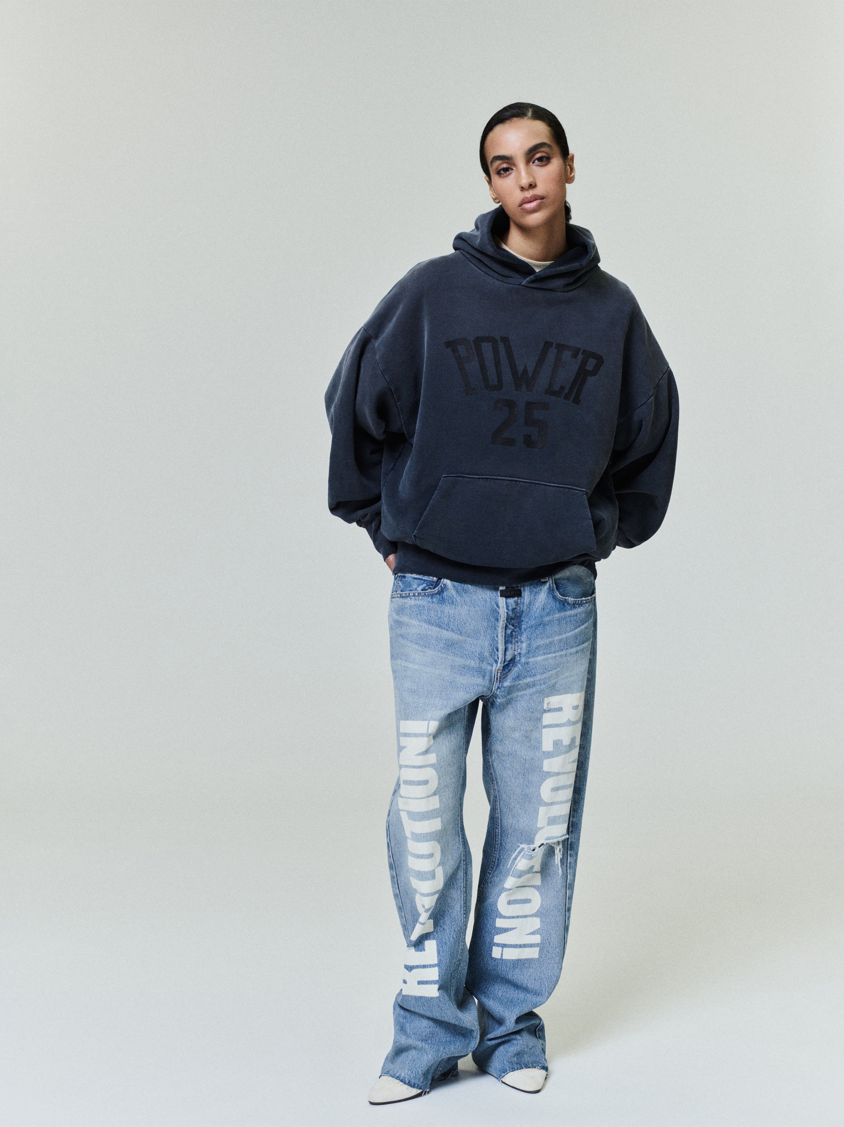 Vintage Power 25 Hoodie in washed navy featuring a relaxed oversized fit and bold textured "POWER 25" text on the front, styled with loose printed denim for casual outerwear.