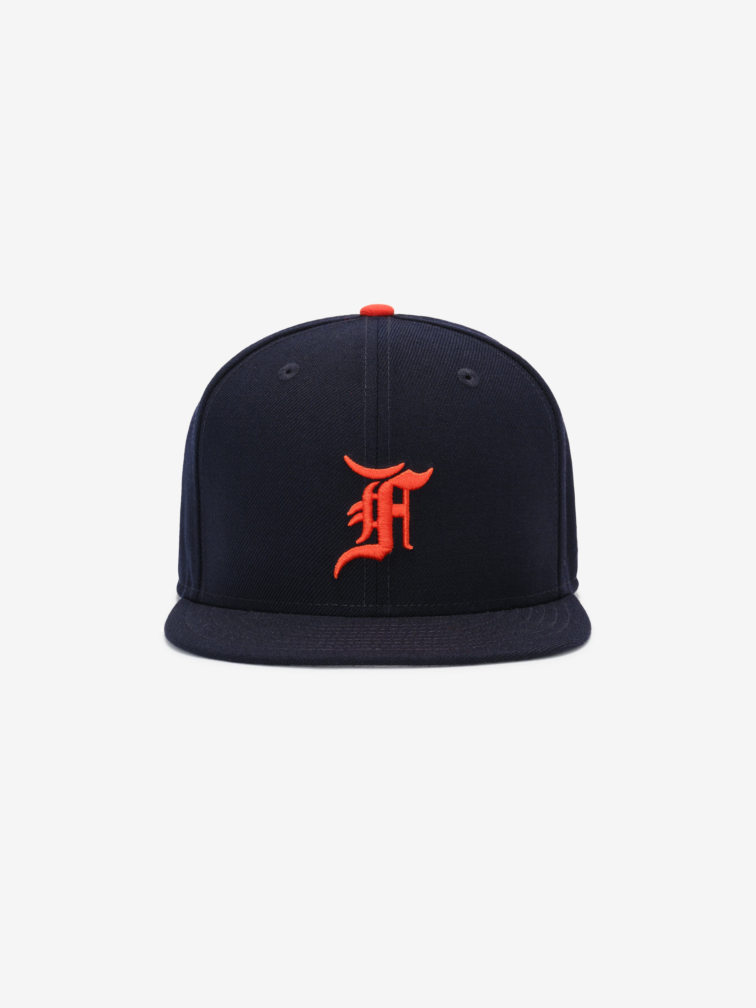 Front view of navy Detroit Tigers cap featuring bright orange Old English D logo and red top button