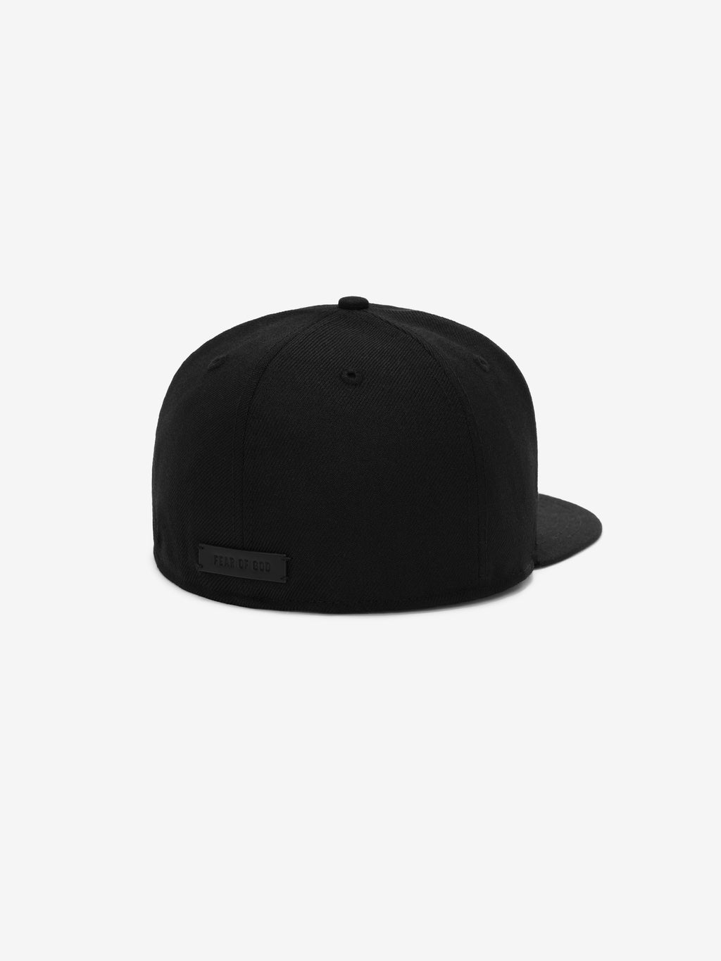 Rear view of a solid black fitted cap with a small black rectangular patch on the back panel against a white background