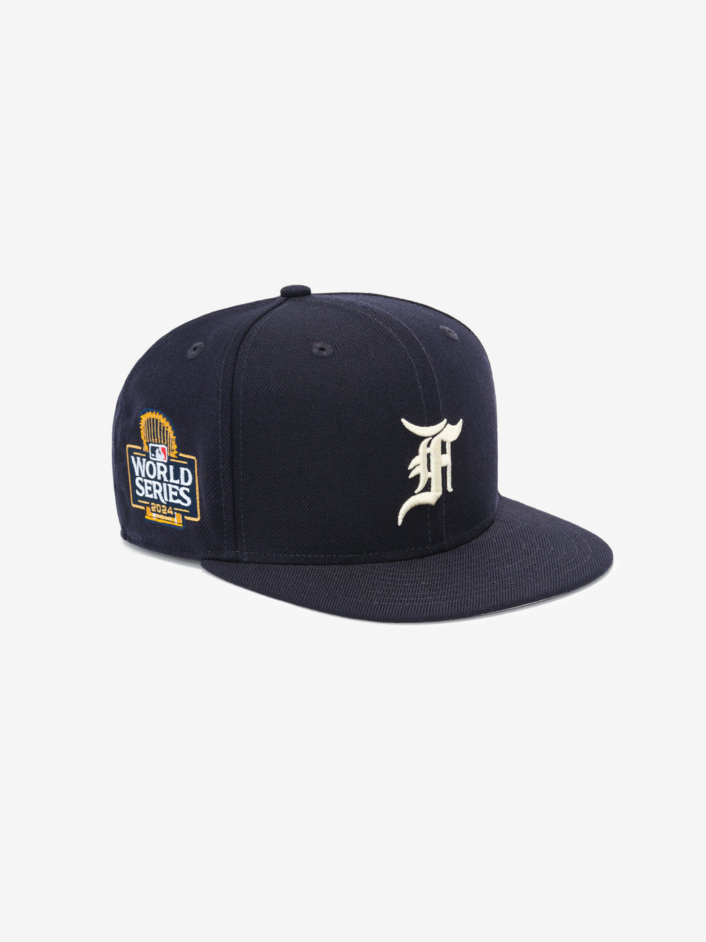 Navy blue structured baseball cap with white ornate letter on front and detailed World Series patch on side panel