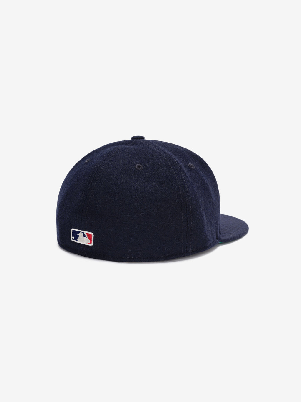 Fear of God Essentials 59FIFTY Retro Fitted FG Cap in deep navy wool fabric, shown from the back with a small stitched Major League Baseball logo near the base of the six-panel crown.