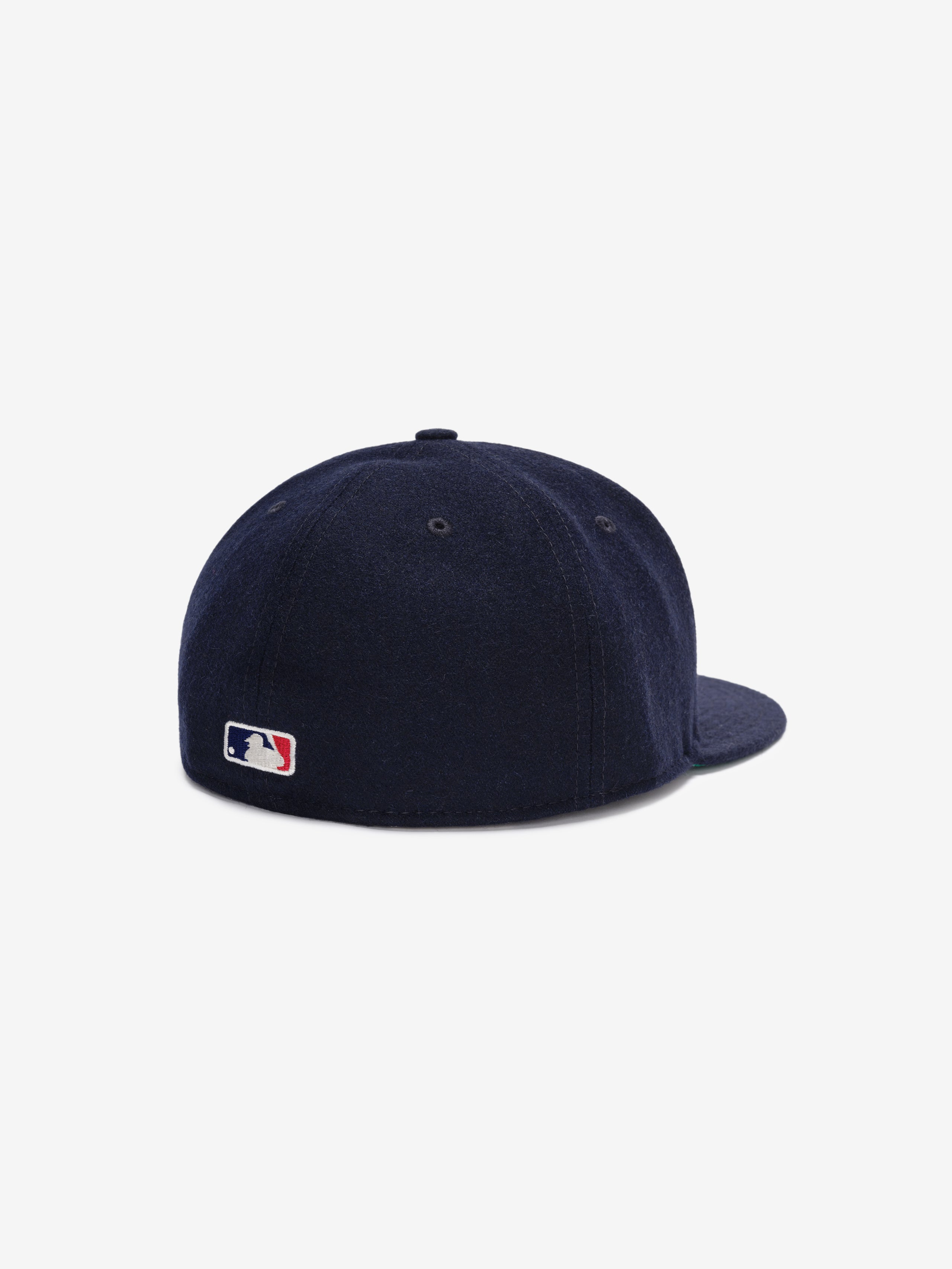 Fear of God Essentials 59FIFTY Retro Fitted FG Cap in deep navy wool fabric, shown from the back with a small stitched Major League Baseball logo near the base of the six-panel crown.