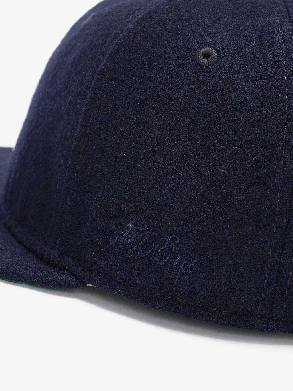 Fear of God Essentials 59FIFTY Retro Fitted FG Cap in navy wool fabric, featuring a subtle tonal New Era script embroidered near the brim on the side panel.
