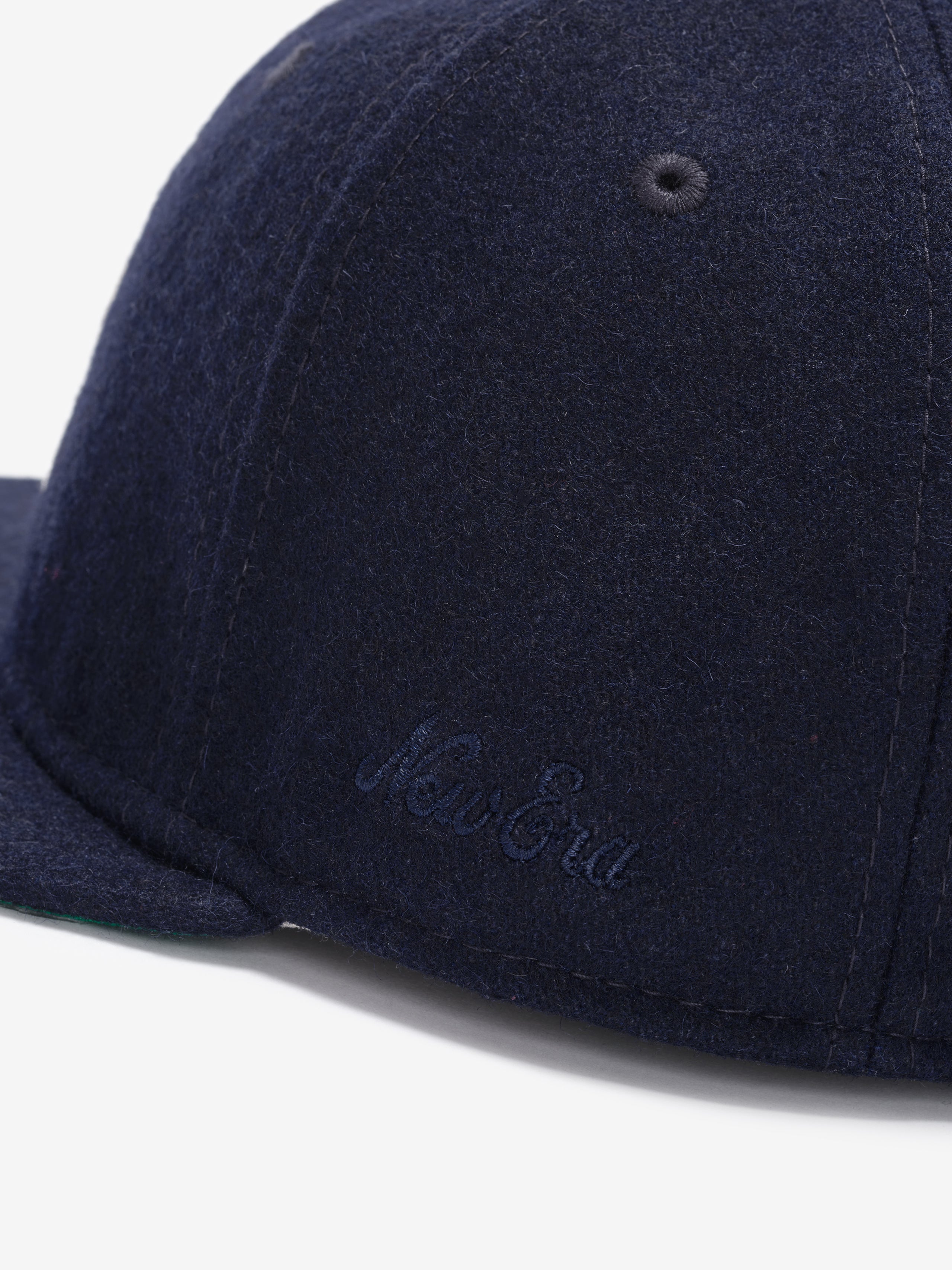 Fear of God Essentials 59FIFTY Retro Fitted FG Cap in navy wool fabric, featuring a subtle tonal New Era script embroidered near the brim on the side panel.