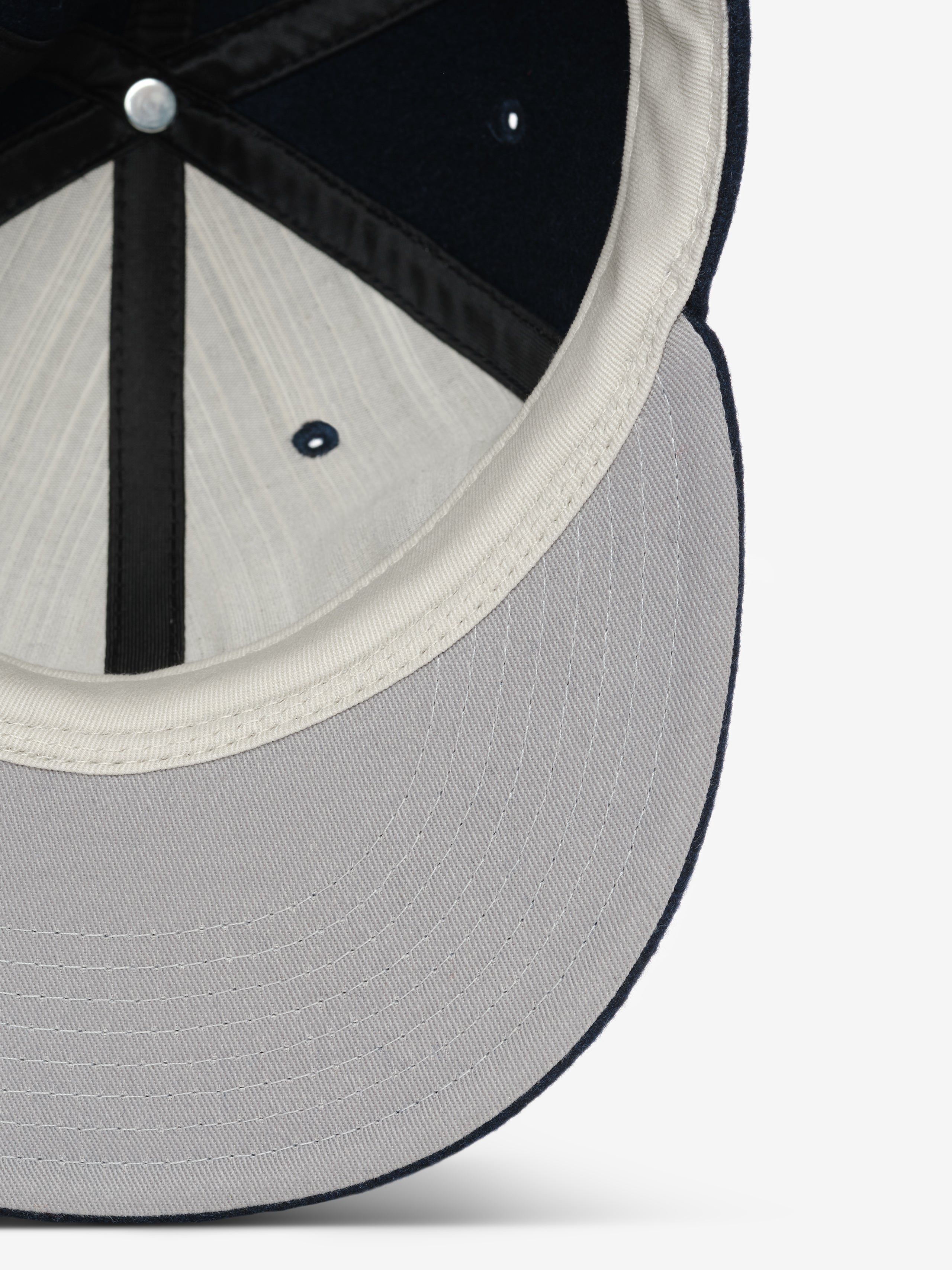 Fear of God Essentials 59FIFTY Retro Fitted National League Cap shown from underneath, highlighting the soft interior lining and structured visor in a subtle two-tone design.