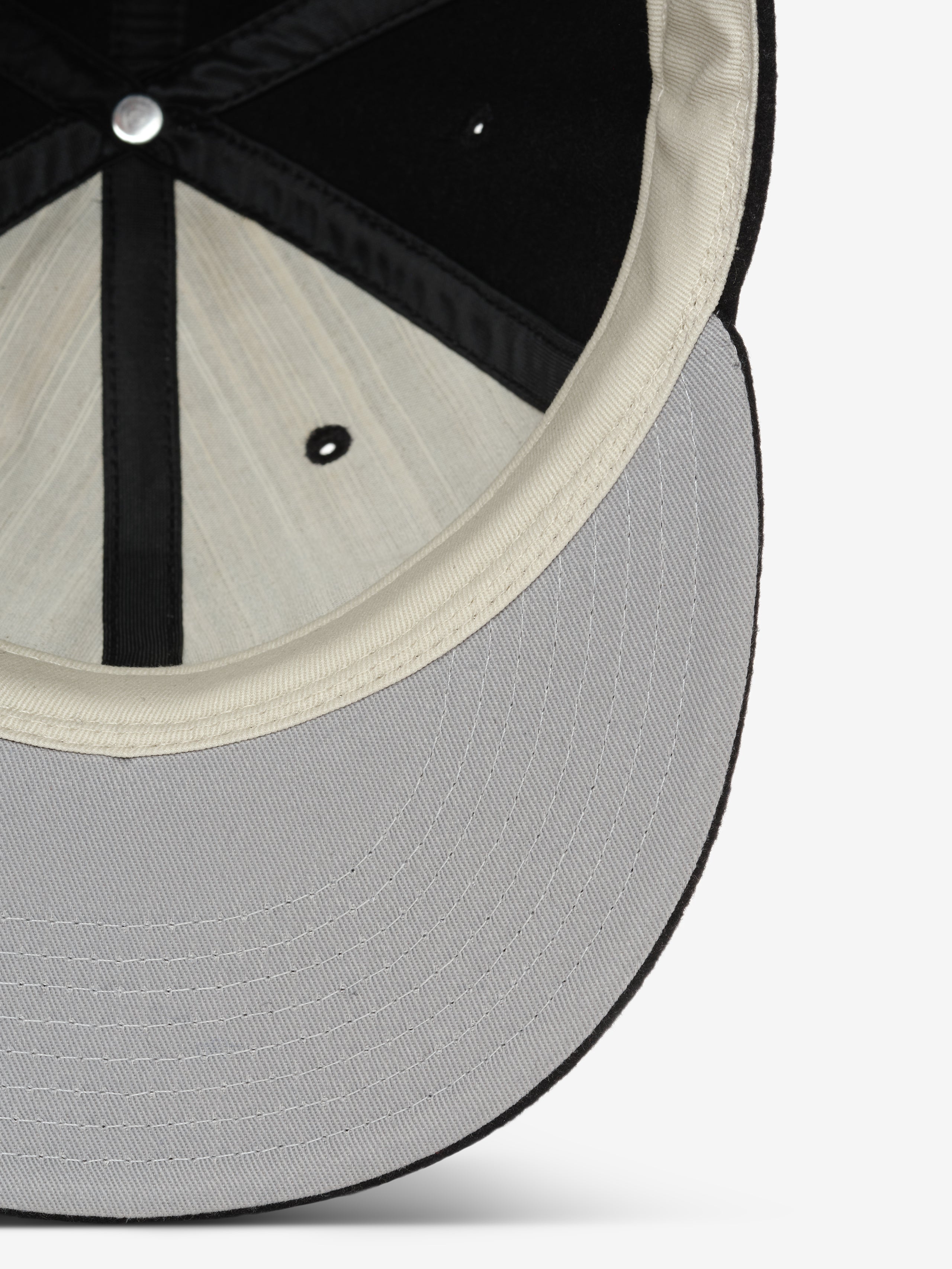 Fear of God Essentials 59FIFTY Retro Fitted American League Cap shown from underneath, highlighting the light grey structured visor and soft inner lining for comfortable wear.